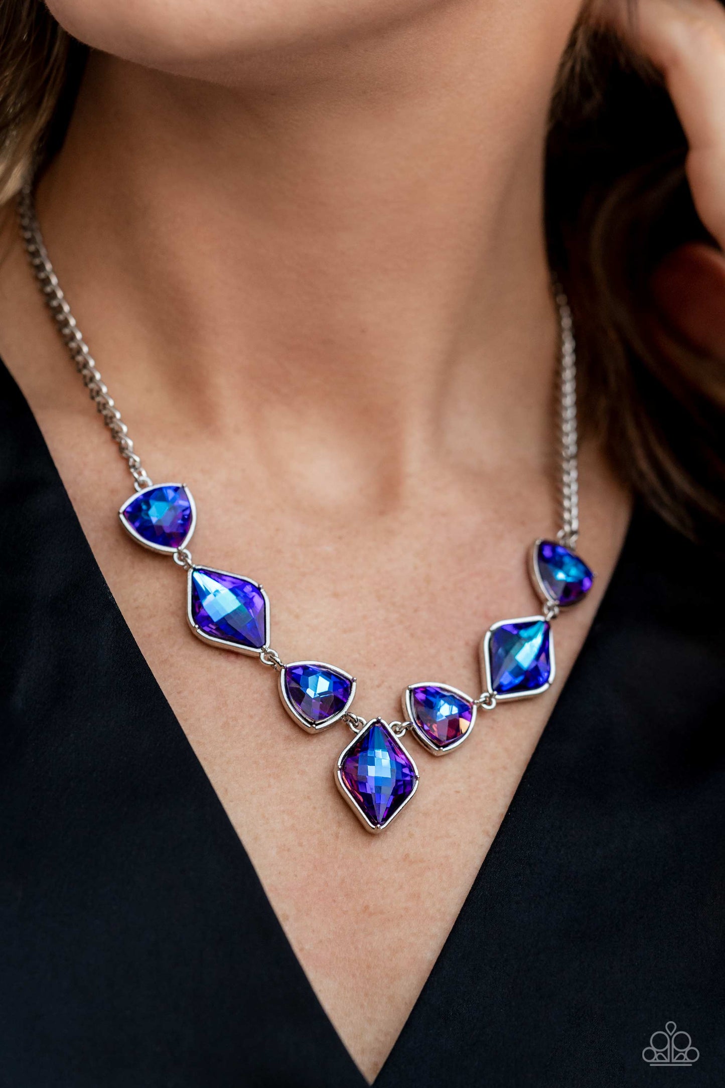 Paparazzi Accessories Glittering Geometrics - Purple Set in silver frames, glittering geometric purple shapes with a UV shimmer delicately coalesce around the collar for a statement piece. Features an adjustable clasp closure. Due to its prismatic palette