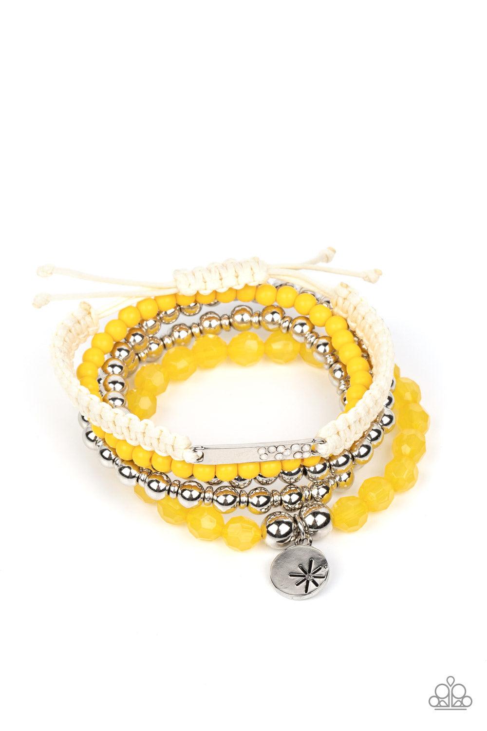 Paparazzi Accessories Offshore Outing - Yellow Strands of yellow beads in the vibrant Pantone® of Samoan Sun are threaded along stretchy elastic bands to create a stack of bracelets. The varying opacities of each yellow bead adds depth to the design, as a