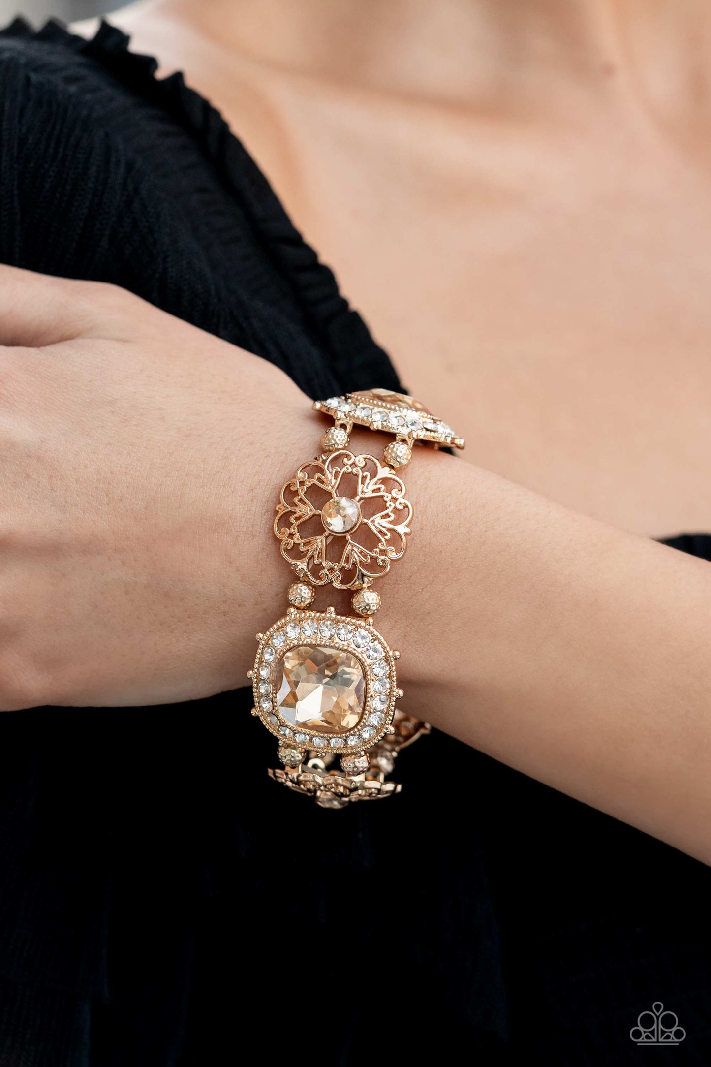 Paparazzi Accessories Gilded Gallery - Gold Oversized faceted golden gems in dramatically rounded square cuts are wrapped in borders of classic white rhinestones, emitting a breathtaking sheen. Floral-inspired frames, dotted with solitaire golden rhinesto