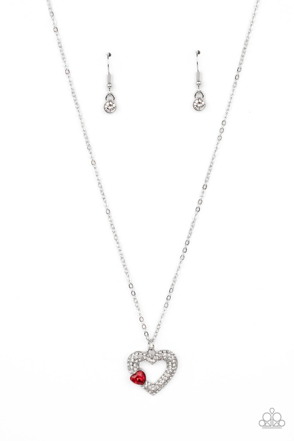 Paparazzi Accessories Bedazzled Bliss - Red A luxurious airy silver heart lush with glassy white rhinestones swings from a classic silver chain. A faceted heart gem brushed in a red shimmer graces one side of the larger bedazzled heart for a romantic fini