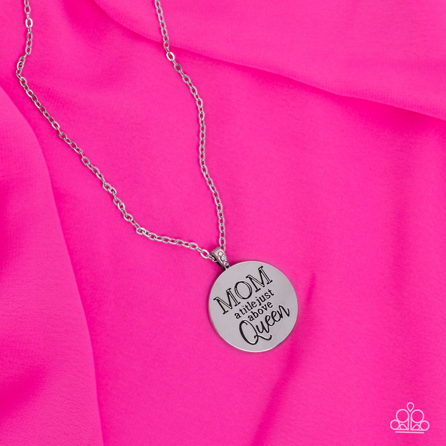 Paparazzi Accessories Mother Dear - Multi At the bottom of a shiny silver chain, a shiny silver disc is stamped with the phrase, "MOM a title just above Queen." The clasp attaching the disc to the chain features a collection of dainty iridescent rhineston