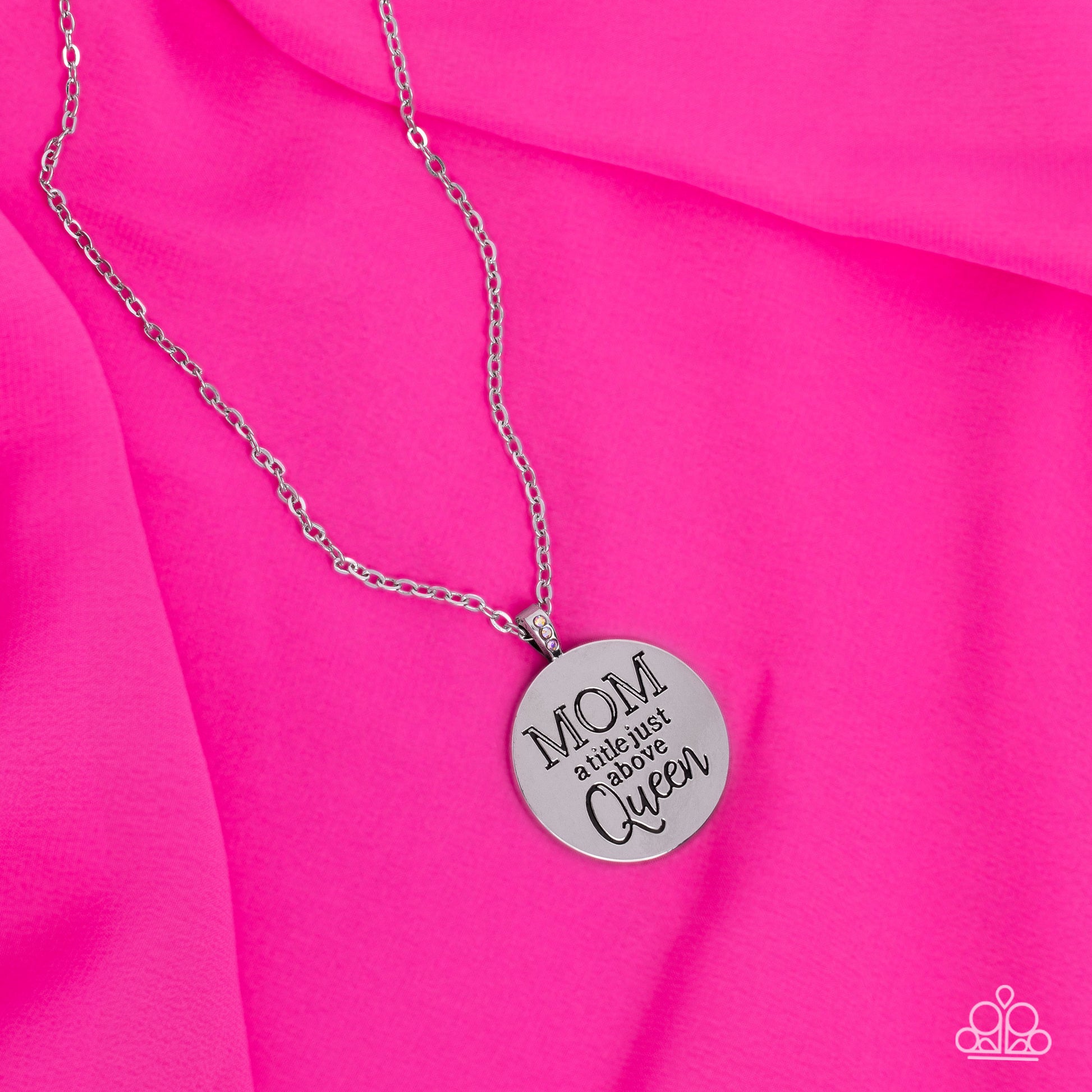 Paparazzi Accessories Mother Dear - Multi At the bottom of a shiny silver chain, a shiny silver disc is stamped with the phrase, "MOM a title just above Queen." The clasp attaching the disc to the chain features a collection of dainty iridescent rhineston