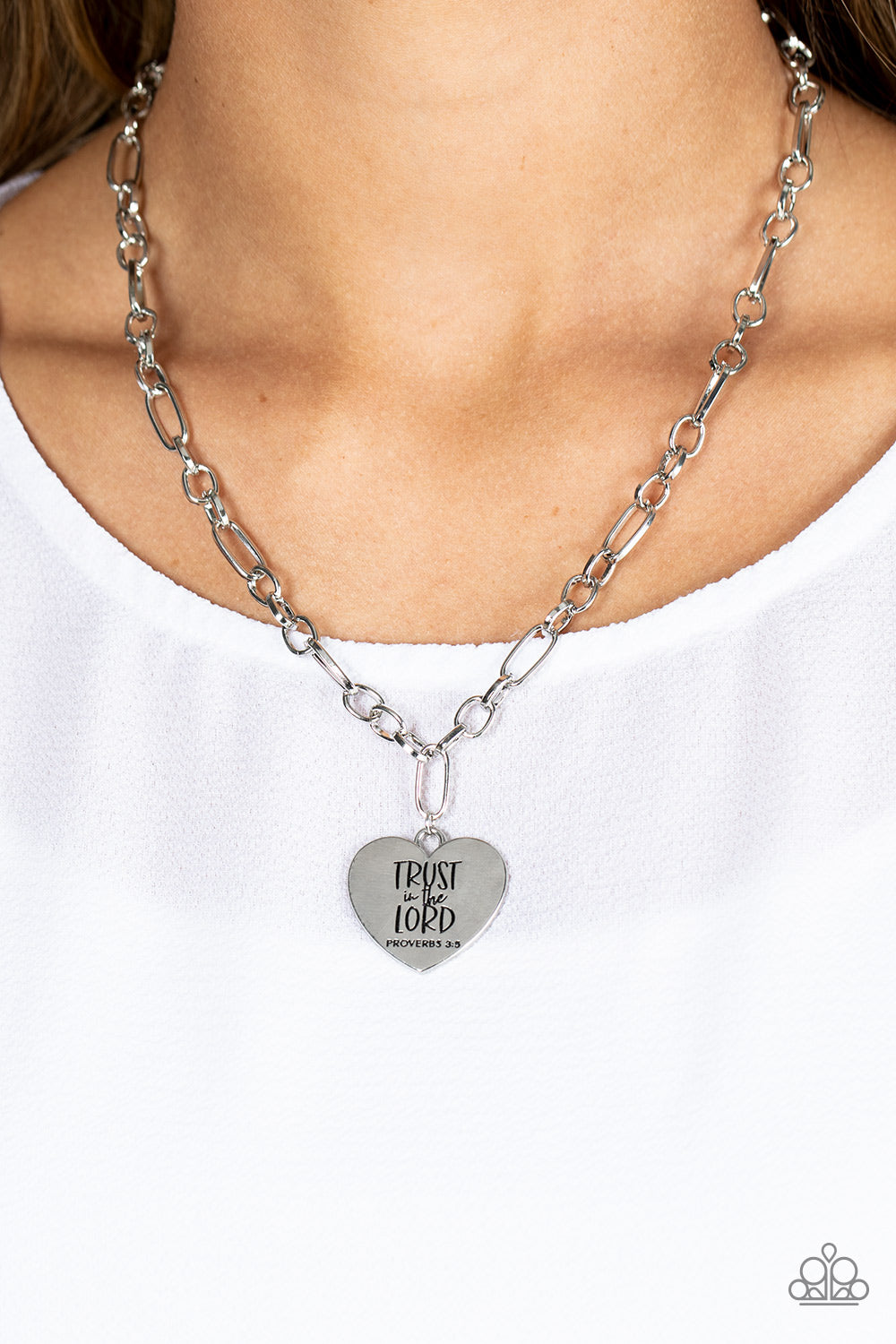 Paparazzi Accessories Perennial Proverbs - Silver Dangling from a silver figaro chain, a charming heart pendant swings. Stamped upon the shiny surface, the phrase "Trust in the Lord" with the bible reference listed below it "Proverbs 3:5" are listed in di