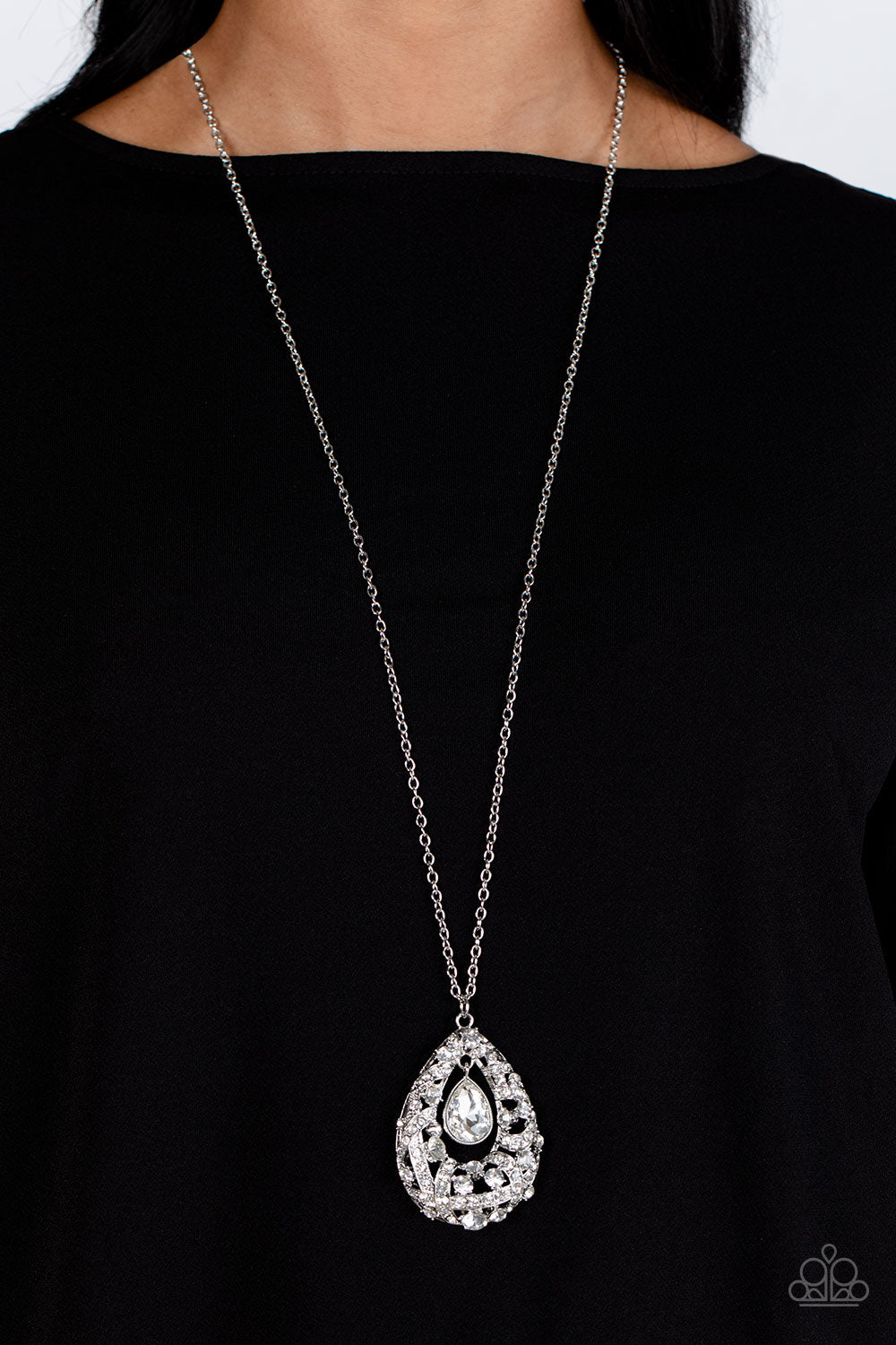 Paparazzi Accessories Glitz and GLOW - White A small teardrop, crystal-like white gem is pressed into a sleek, silver frame as it's suspended from a larger gem and rhinestone-dusted airy teardrop frame. The various sizes of crystal-like gems and white rhi