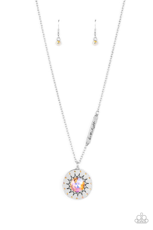 Paparazzi Accessories Sundial Dance - Orange Hanging from the bottom of a classic silver chain, a silver pendant, with a lightly hammered sheen rests. Stamped on the pendant, a sun outlines the center with dainty orange rhinestones outlining the shape. Br