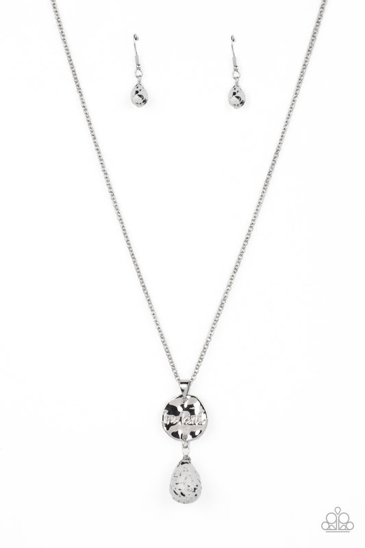 Paparazzi Accessories Caring Couture - White Swinging from a dainty silver chain, a hammered disc in the same hue is stamped with the words "be kind." A chiseled white speckled teardrop hangs from the bottom of the pendant adding a fashionably rustic feat