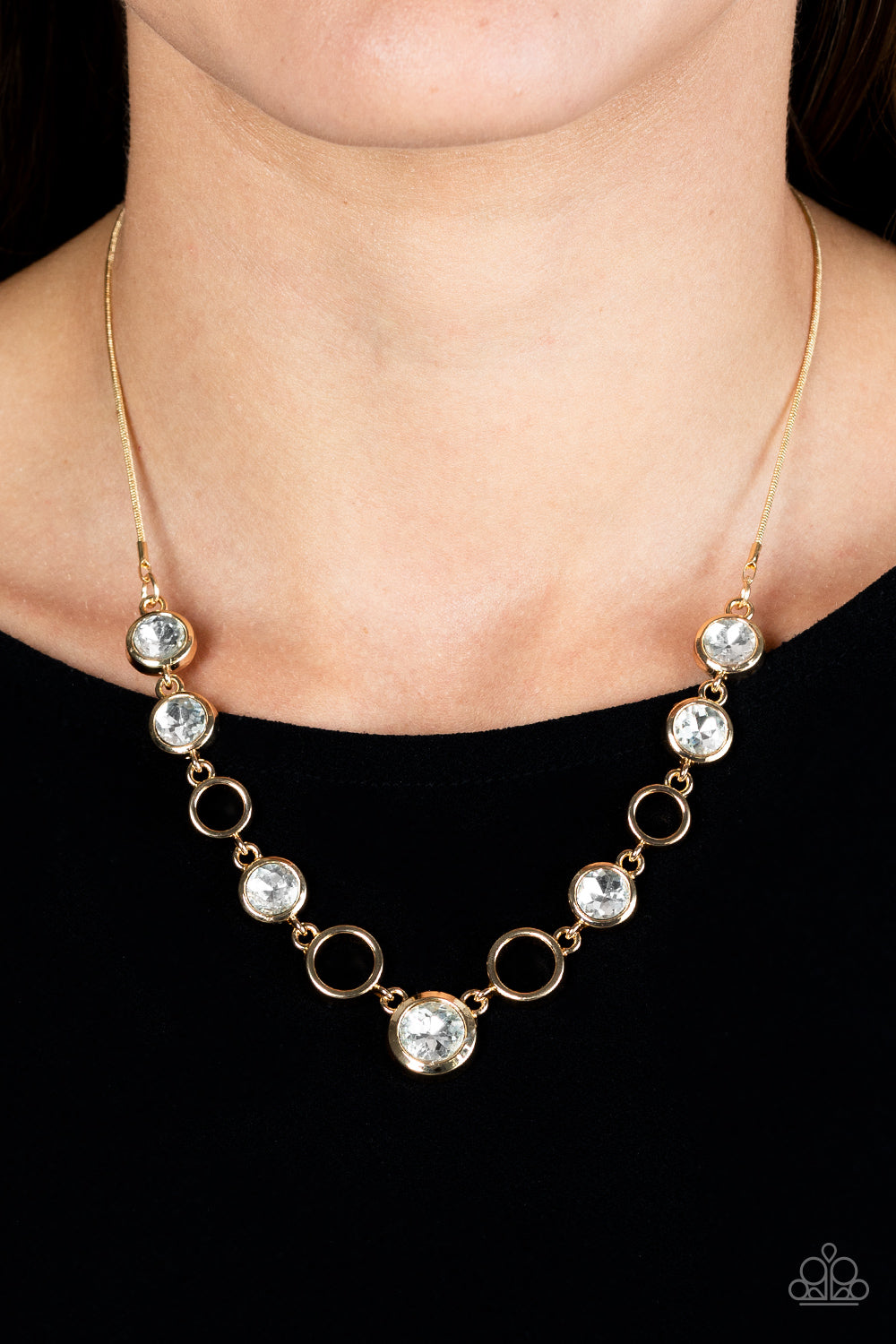 Paparazzi Accessories Elegantly Elite - Gold Thick airy gold hoops interlock with round brilliant-cut white rhinestones set in similar thick frames for an unmatched elegant sparkle. Features an adjustable clasp closure. Sold as one individual necklace. In
