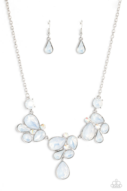 Paparazzi Accessories Everglade Escape - White Draped elegantly across the chest, clusters of geometric white gems, brushed in an opalescent shimmer, gather around sparkling iridescent rhinestones, creating a bright and beautiful pattern. Features an adju