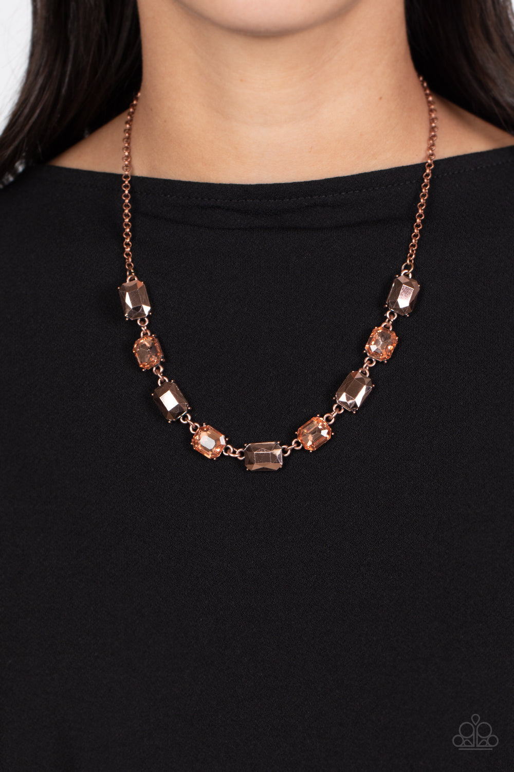 Paparazzi Accessories Emerald Envy - Copper A dazzling collection of emerald-cut gems splashed in peachy hues, and coppery aurum are featured in this stunning statement piece. The aurum emerald-cut beads cascade down the neck from a classic copper chain f