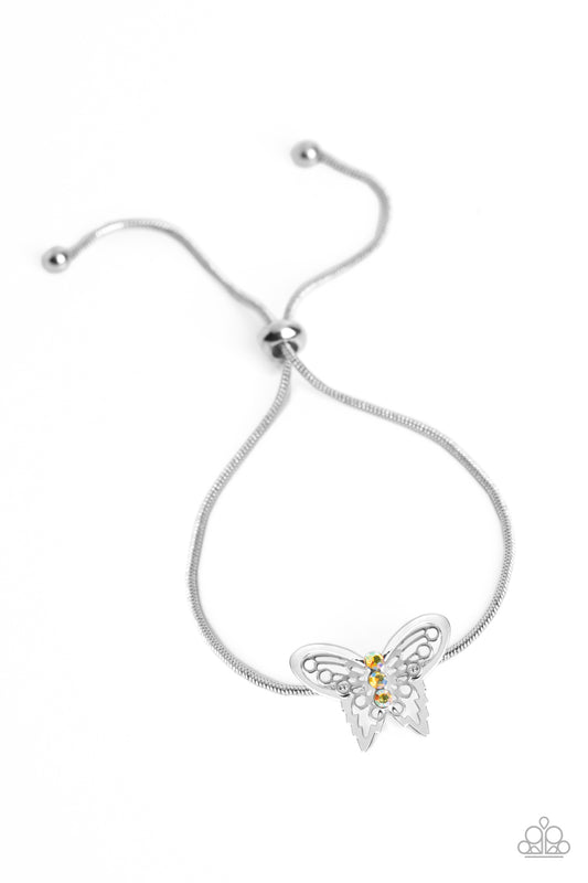 Paparazzi Accessories Wings of Wonder - Yellow A deceptively simple silver butterfly charm glides along a silver snake chain for a whimsical flair along the wrist. Dainty, yellow rhinestones, brushed in a UV shimmer, encrust along the butterfly's body, cr