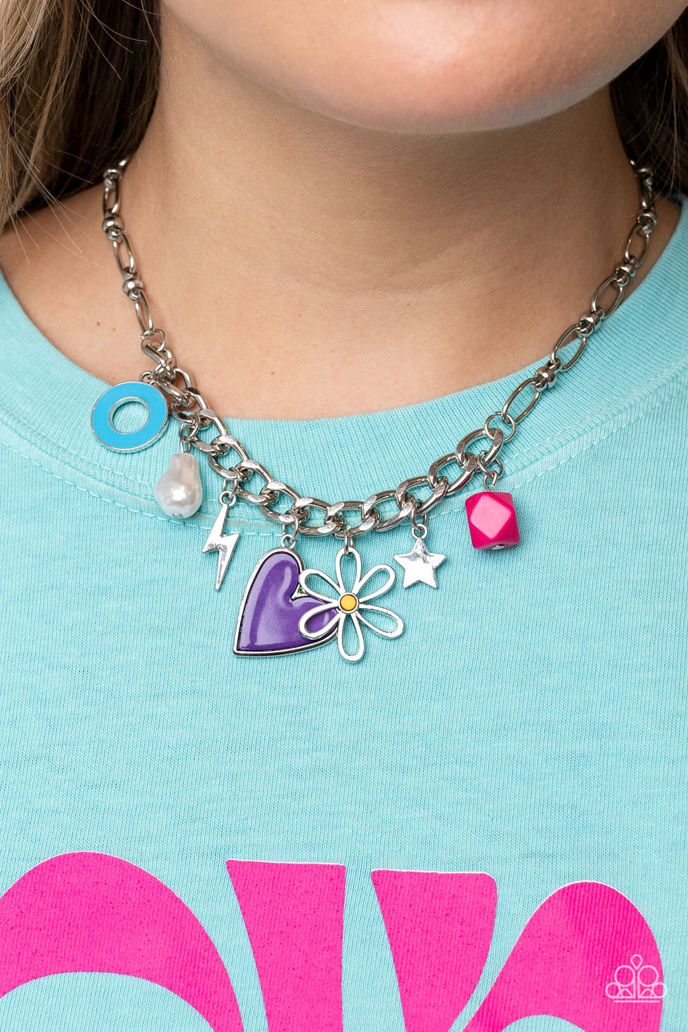 Paparazzi Accessories Living in CHARM-ony - Purple Elongated silver chain links, separated by tiny silver beads, lead down the neckline to a section of thick, flat, silver curb chain. A collection of whimsical charms gather along the thicker chain, includ