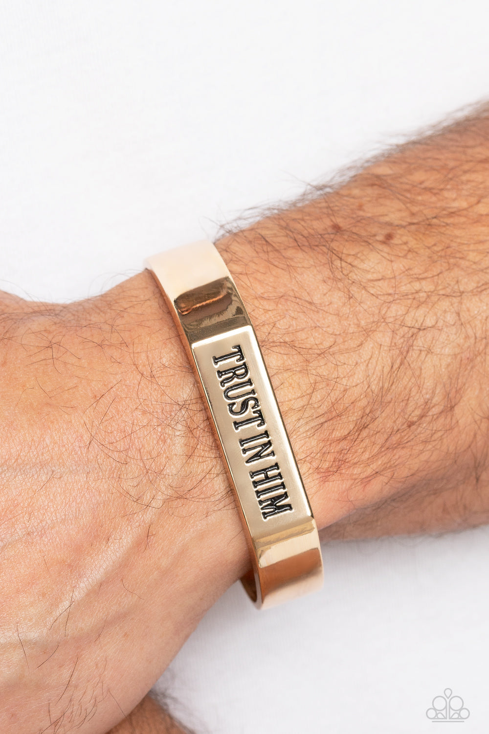 Paparazzi Accessories Trusting Trinket - Gold A thick, gold cuff coalesces into an edgy, urban statement across the wrist. Stamped on the center-most rectangular plate, the phrase "Trust in Him" boldly stands out for an inspirational finish. Sold as one i