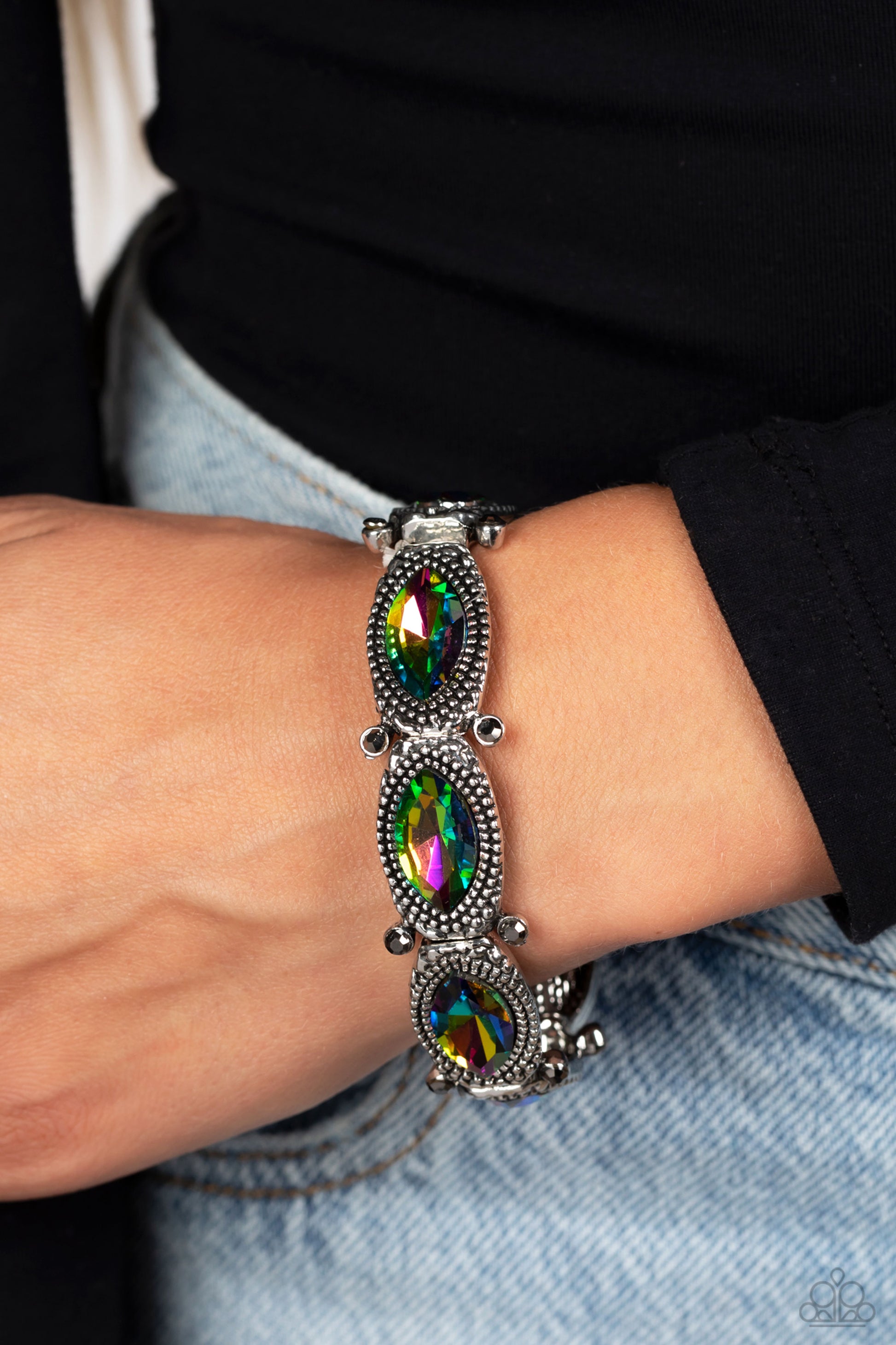 Paparazzi Accessories Dancing Diva - Multi Glittery oil spill gems are pressed into silver studded, marquise-cut frames, titled on its side. Separated by dainty hematite rhinestones encased in sleek silver frames, the sparkly collection is threaded along