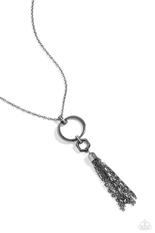 Paparazzi Accessories Tassel Tune - Black A shimmery gunmetal, oval hoop swings from the bottom of an elegantly elongated gunmetal chain for a refined look. Attached to the hoop and chain by a rhinestone-encrusted oval, a hexagonal-shaped frame swings. Co