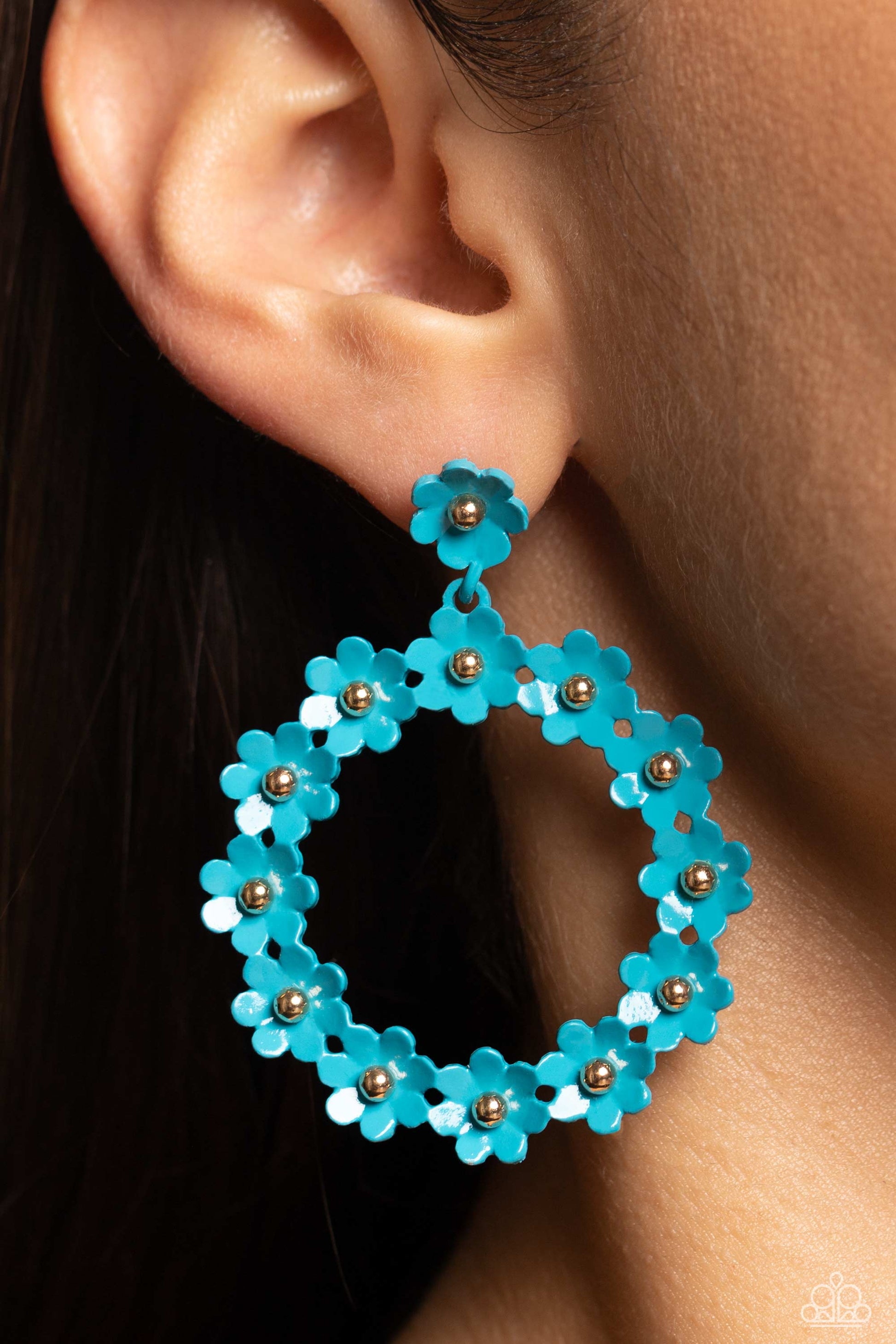 Paparazzi Accessories Daisy Meadows - Blue Hanging from a solitaire blue daisy, a dainty collection of blue daisies bloom into a free-spirited wreath below the ear. Gold studs gleam from the centers of the tactile flowers, adding an industrial sheen to th