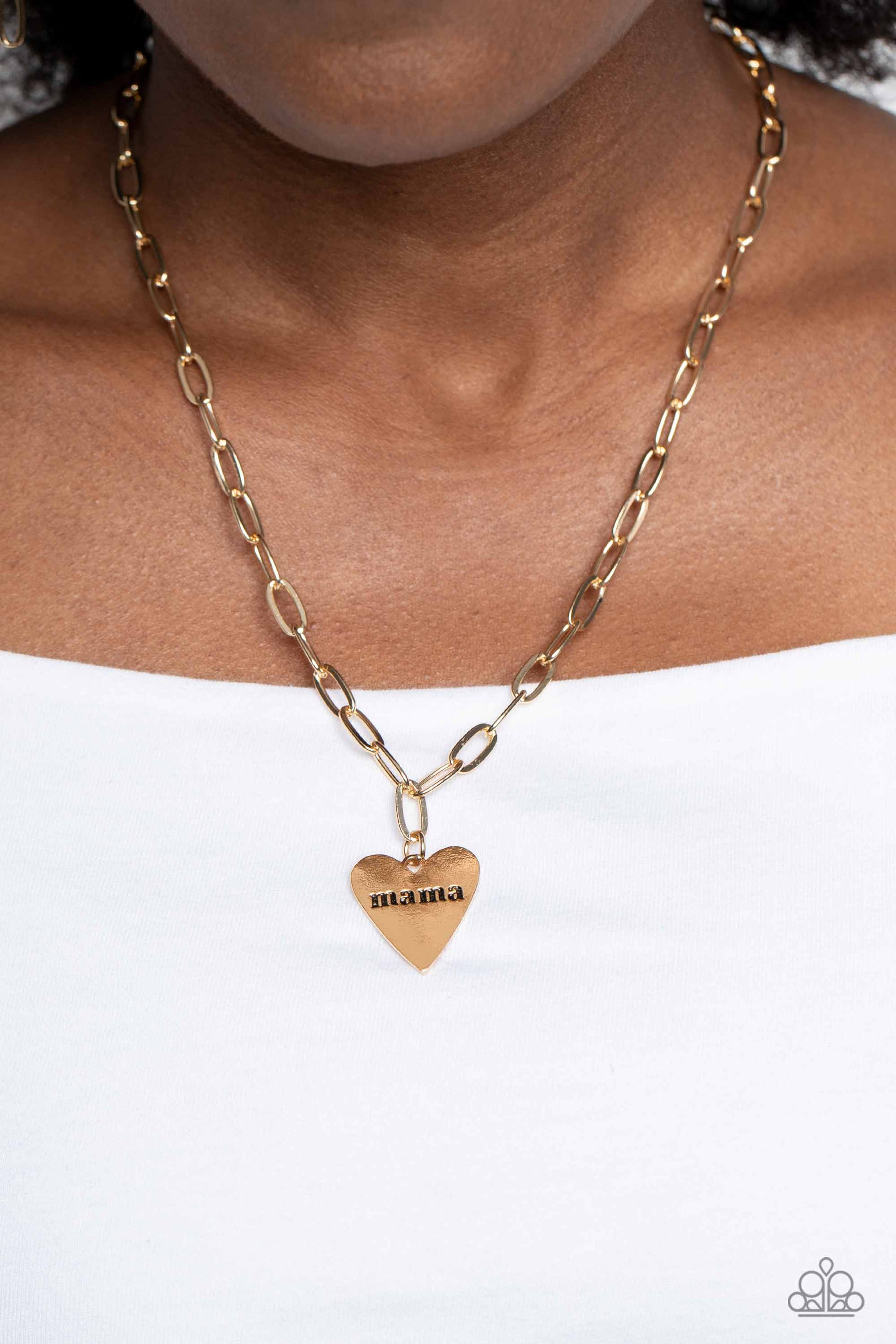 Paparazzi Accessories Mama Cant Buy You Love - Gold High-sheen gold ovals link down the chest drawing attention to the gold heart pendant at its bottom. Stamped with the word "mama" in its center, this monochromatic masterpiece gives off a simplistic, sen