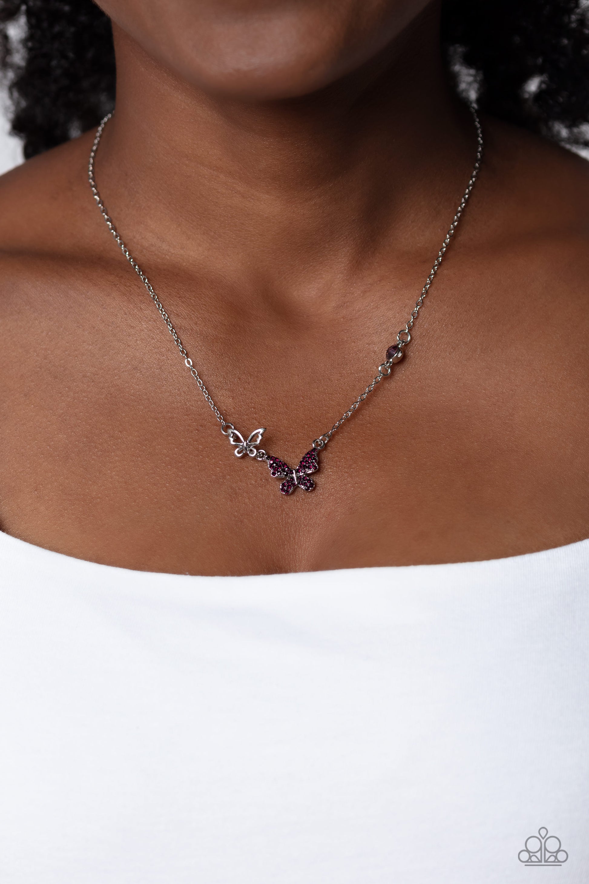 Paparazzi Accessories Cant BUTTERFLY Me Love - Purple A silver butterfly, dotted in dainty amethyst rhinestones, hangs from the bottom of a dainty silver chain. A smaller, airy silver butterfly appears to be in mid-flight as it's tilted to its side and be