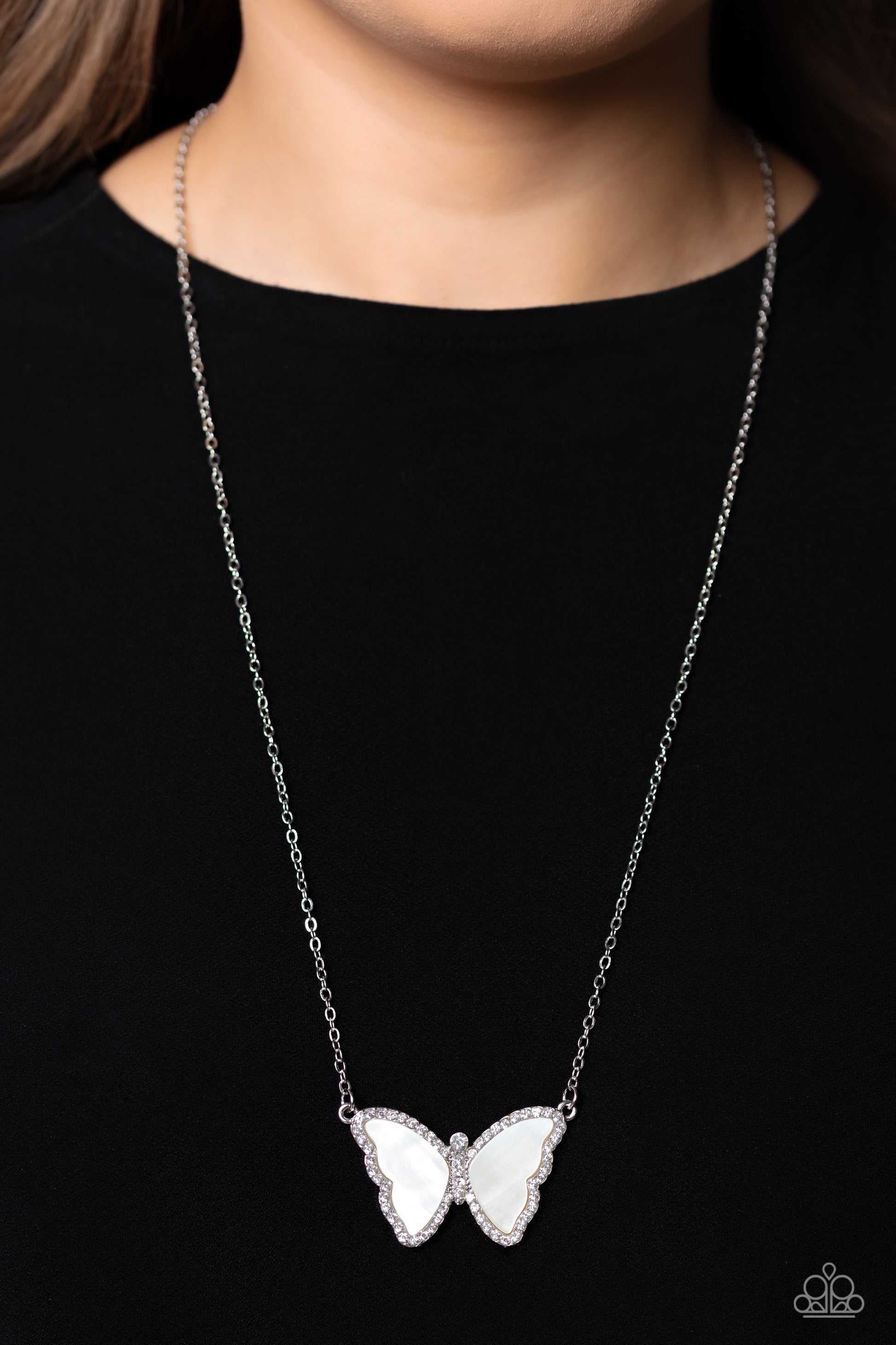 Paparazzi Accessories SHELL-bound - White Shimmery white shells are encased inside a silver butterfly frame, creating its wings. Bordering the shell wings and encrusted along the butterfly's body, are white rhinestones that shimmer and shine at the bottom