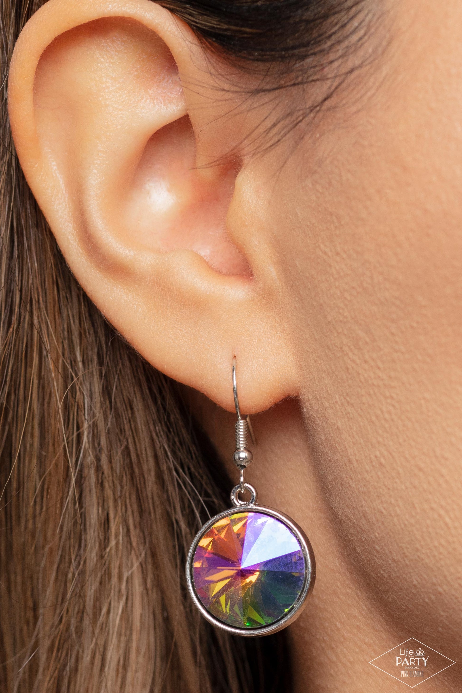 Paparazzi Accessories She Sparkles On - Multi A dramatic gem with a UV shimmer swings from the bottom of a shiny silver chain, creating a blinding pendant below the collar. Features a toggle closure. Due to its prismatic palette, color may vary. Sold as o