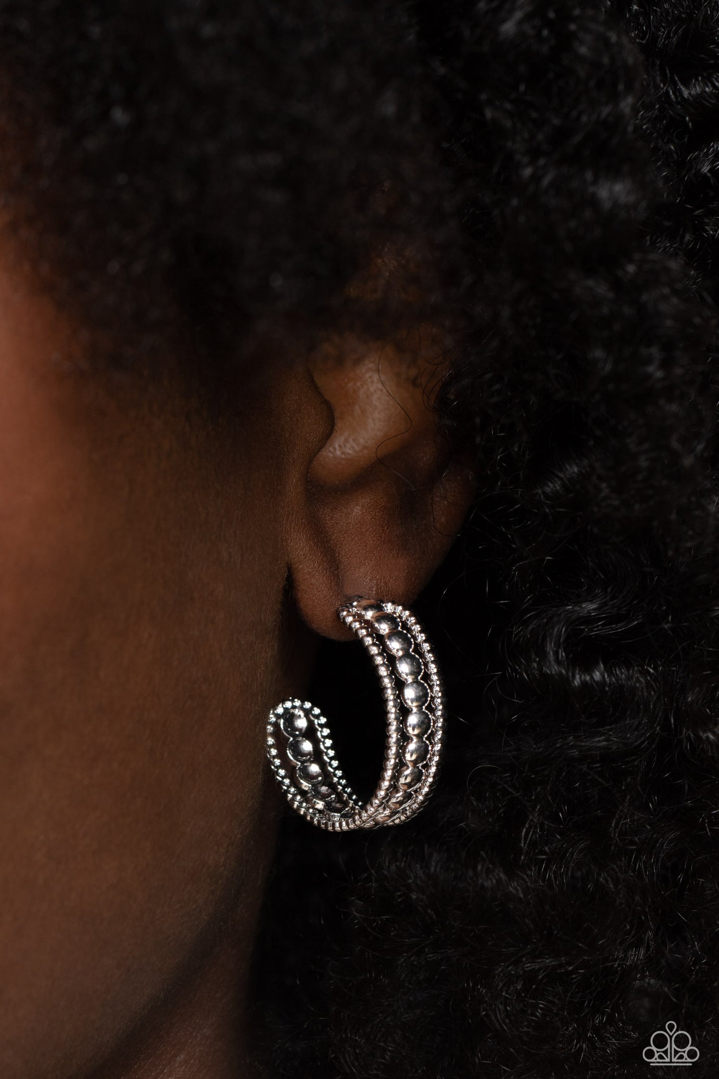 Paparazzi Accessories Dotted Darling - Silver A row of high-sheen silver studs runs down the center of an airy silver hoop for an edgy look. Layering against the centermost studs, smaller silver studs grace both sides of the hoop creating additional eye-c