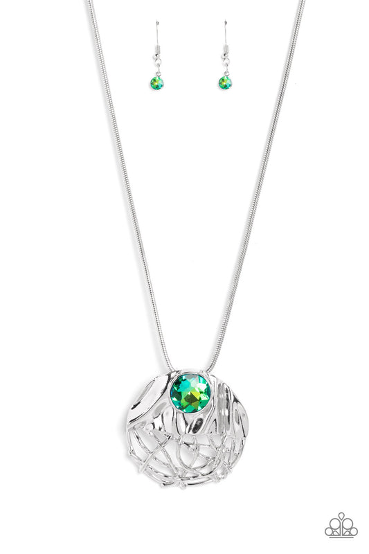 Paparazzi Accessories Lush Lattice - Green Mimicking a lattice-like pattern, abstract silver lines flow from the bottom of an oversized, hammered, silver half-circle pendant that attaches to a shimmery silver snake chain. Within the folds of the silver ha