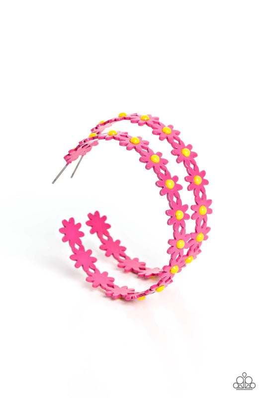 Paparazzi Accessories Daisy Disposition - Pink A dainty collection of hot pink daisies with yellow centers blooms into a free-spirited hoop around the ear. Earring attaches to a standard post fitting. Hoop measures approximately 2" in diameter. Sold as on
