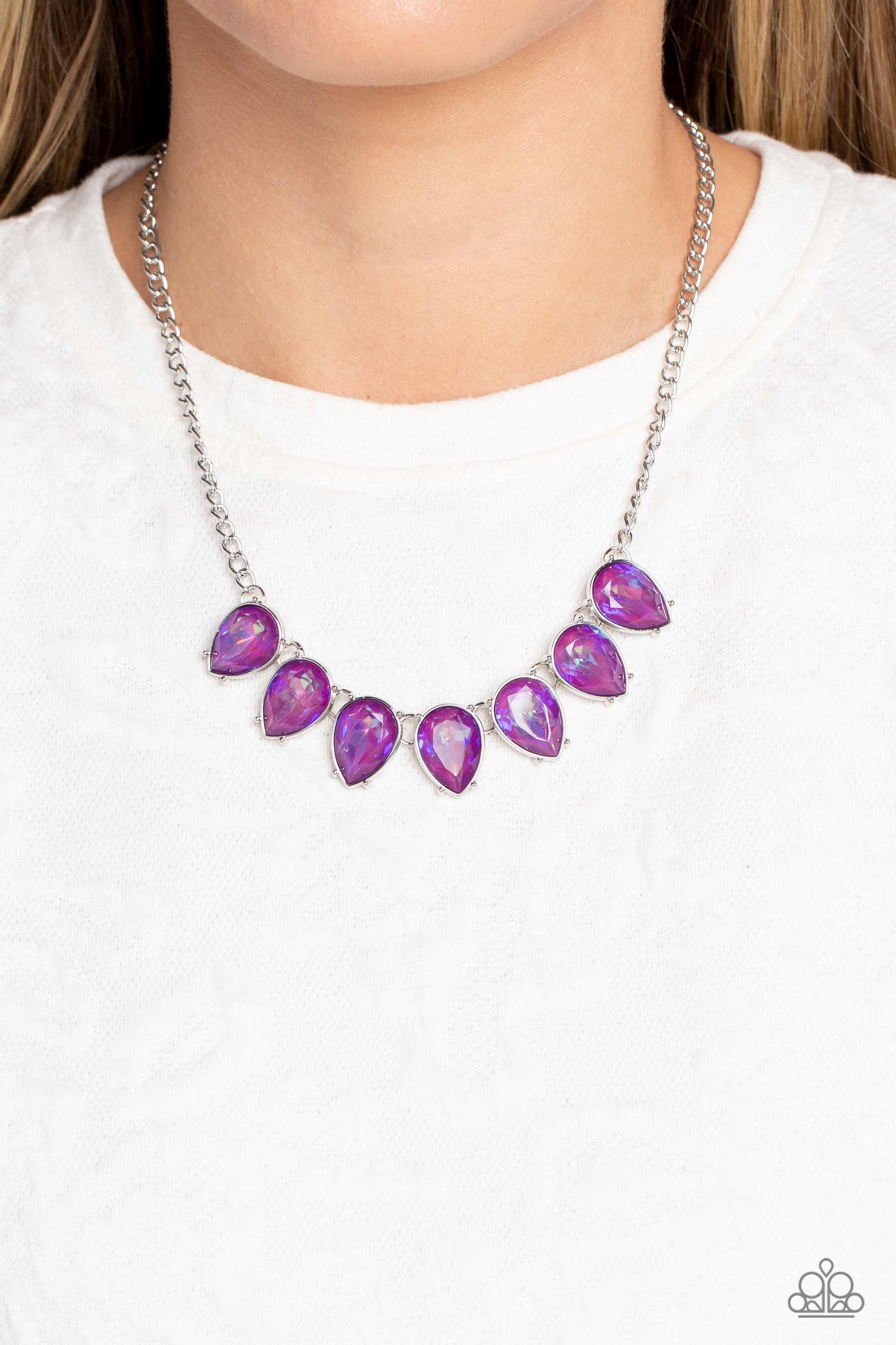 Paparazzi Accessories FLIRTY Dancing - Purple Gliding down a classic silver chain, a twinkling collection of silver-pronged, amethyst, reflective, upside down teardrops glitter down the chest. The sparkly and sharp display fearlessly dances to its own bea