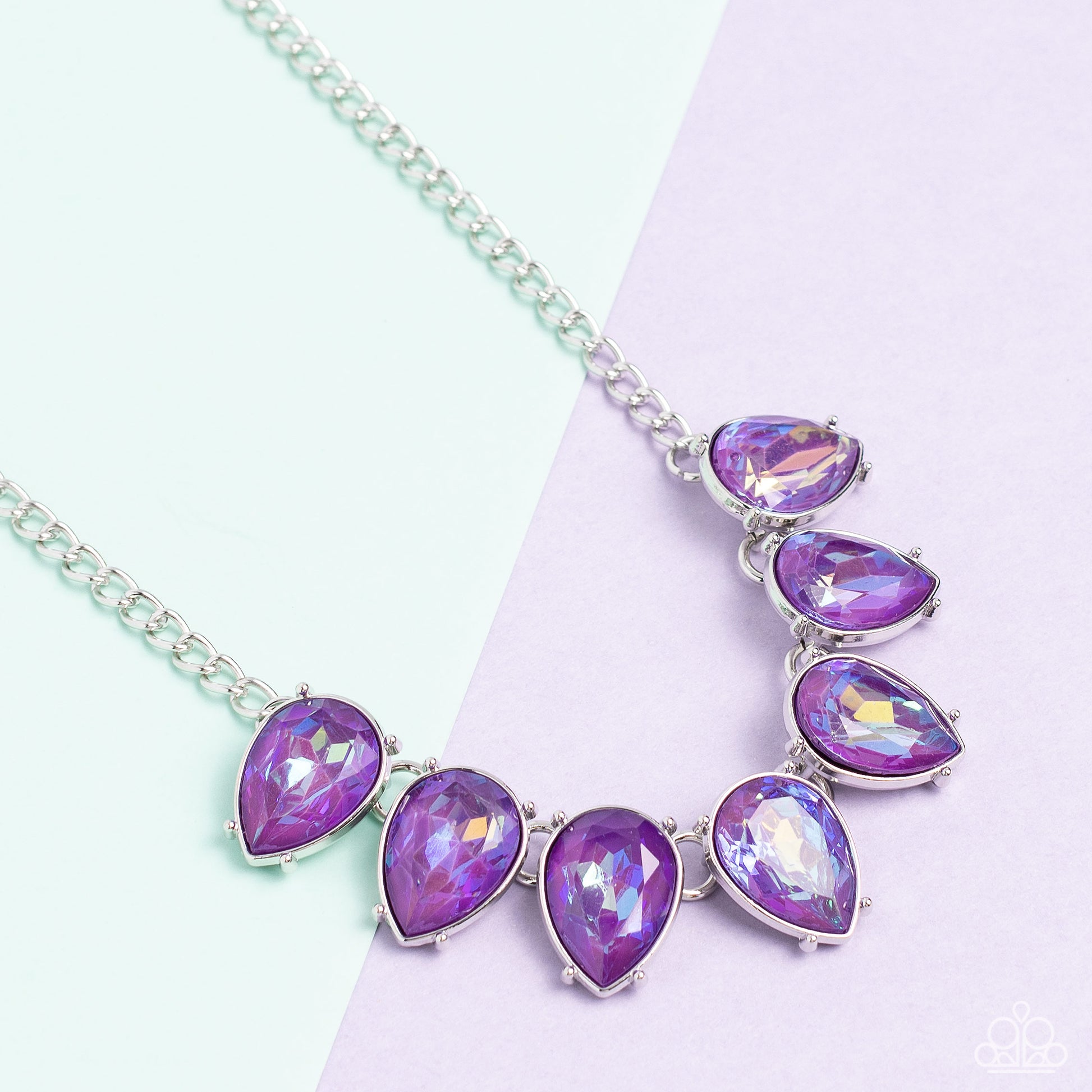 Paparazzi Accessories FLIRTY Dancing - Purple Gliding down a classic silver chain, a twinkling collection of silver-pronged, amethyst, reflective, upside down teardrops glitter down the chest. The sparkly and sharp display fearlessly dances to its own bea