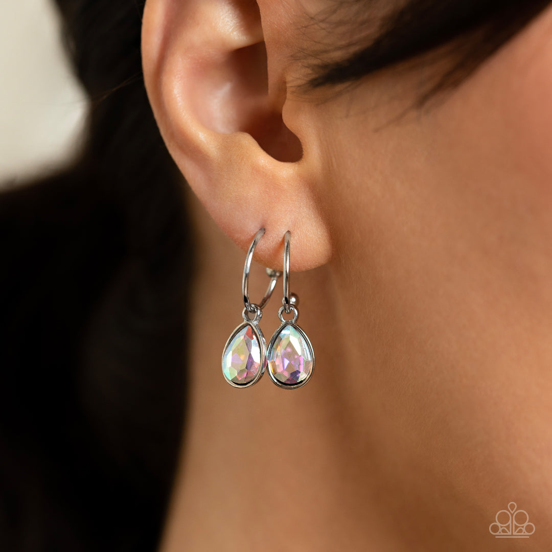 Paparazzi Accessories Teardrop Tassel - Multi A small, skinny, shiny silver hoop curves around the ear in a timeless fashion. A shiny silver ball is affixed to the end of the hoop, reminiscent of a barbell fitting. An iridescent, teardrop gem, encased in