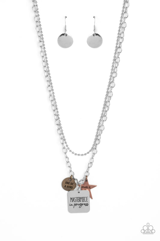 Paparazzi Accessories Masterpiece in Progress - Multi Featuring three inspirational pendants, a copper star, brass circle, and silver square fall along a silver chain. The star features the phrase "own it," the circle features the phrase "one of a kind,"