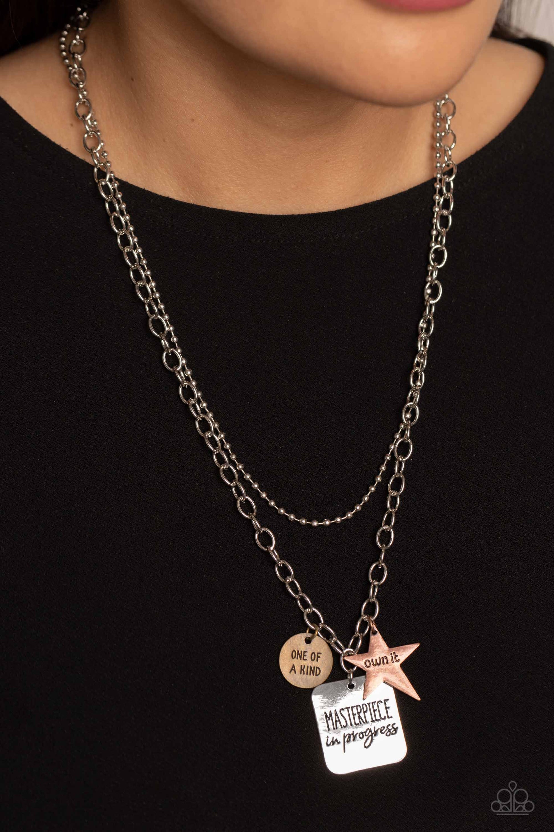 Paparazzi Accessories Masterpiece in Progress - Multi Featuring three inspirational pendants, a copper star, brass circle, and silver square fall along a silver chain. The star features the phrase "own it," the circle features the phrase "one of a kind,"