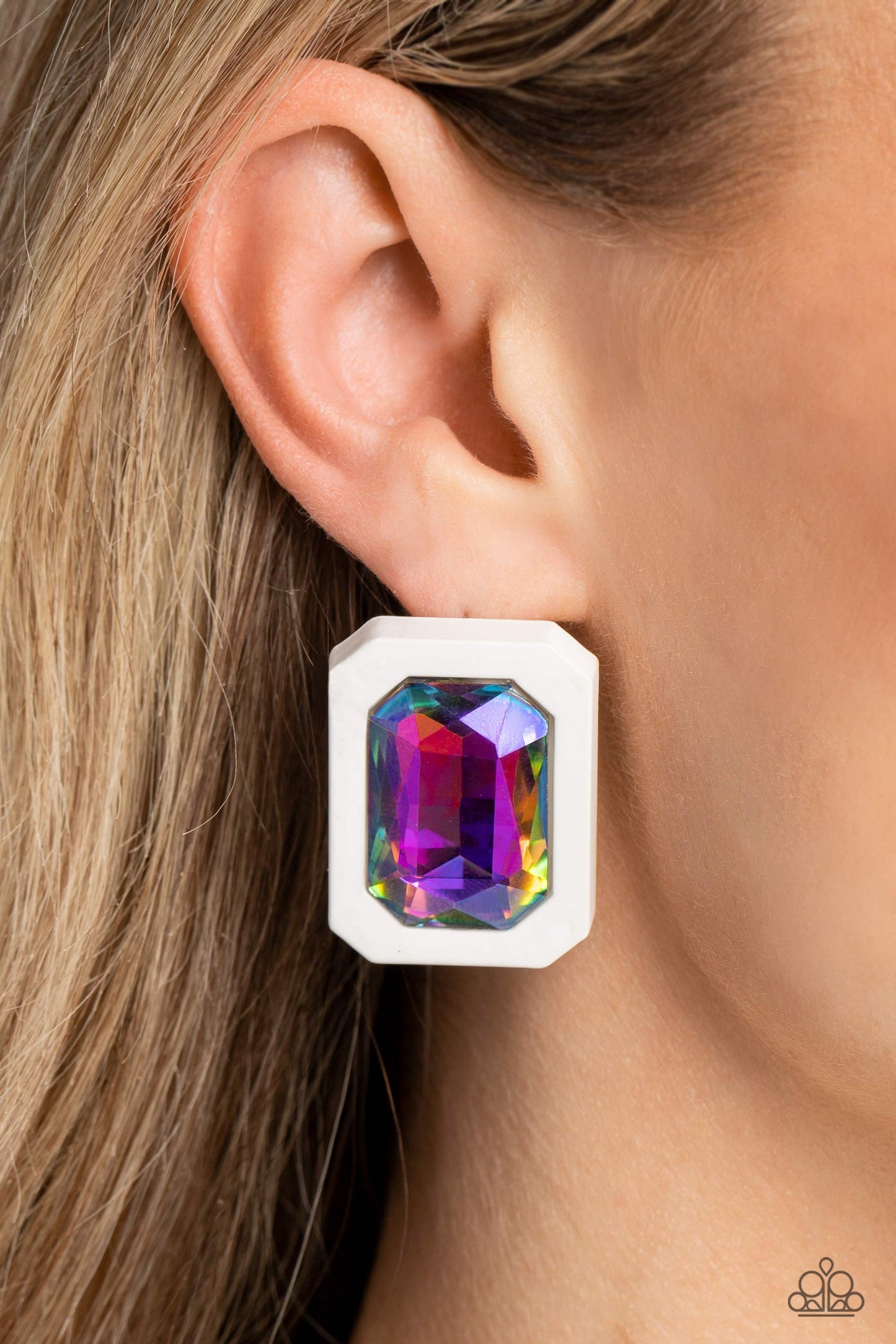 Paparazzi Accessories Edgy Emeralds - Multi Standing out against a white rubber backdrop, an oversized, faceted emerald-cut colorfully reflective gem shimmers and shines for an edgy sparkle against the ear. Earring attaches to a standard post fitting. Due