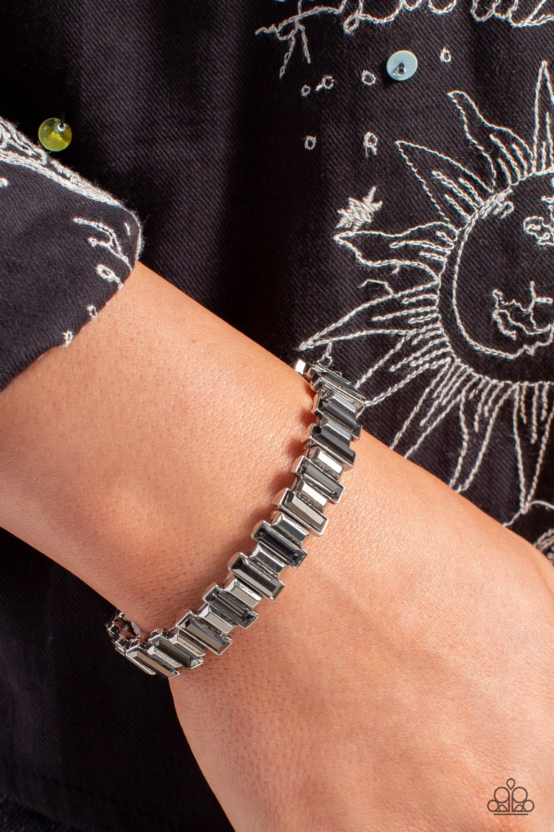 Paparazzi Accessories BURSTING the Midnight Oil - Silver Set in clusters around the wrist on elastic stretchy bands, a collection of shiny silver bars with a metallic finish and smoky bars with a reflective finish glimmer for an industrial, glitzy, statem