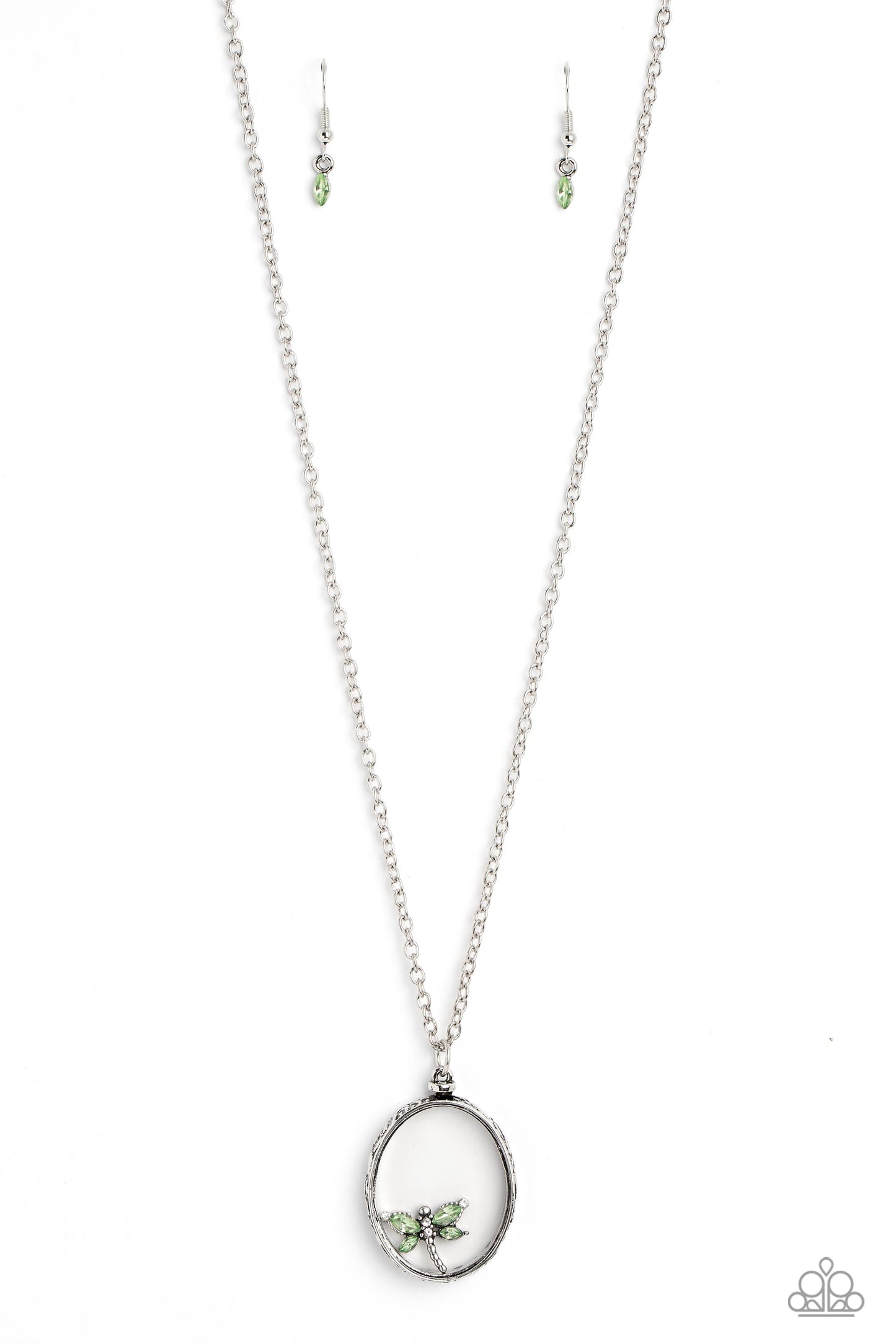 Paparazzi Accessories Dynamic Dragonfly - Green Falling from a high-sheen silver chain, a thick oval pendant with a faceted clear center lengthens the torso as it swings from the bottom of the chain. Swinging from the center of the shimmery pendant, an in