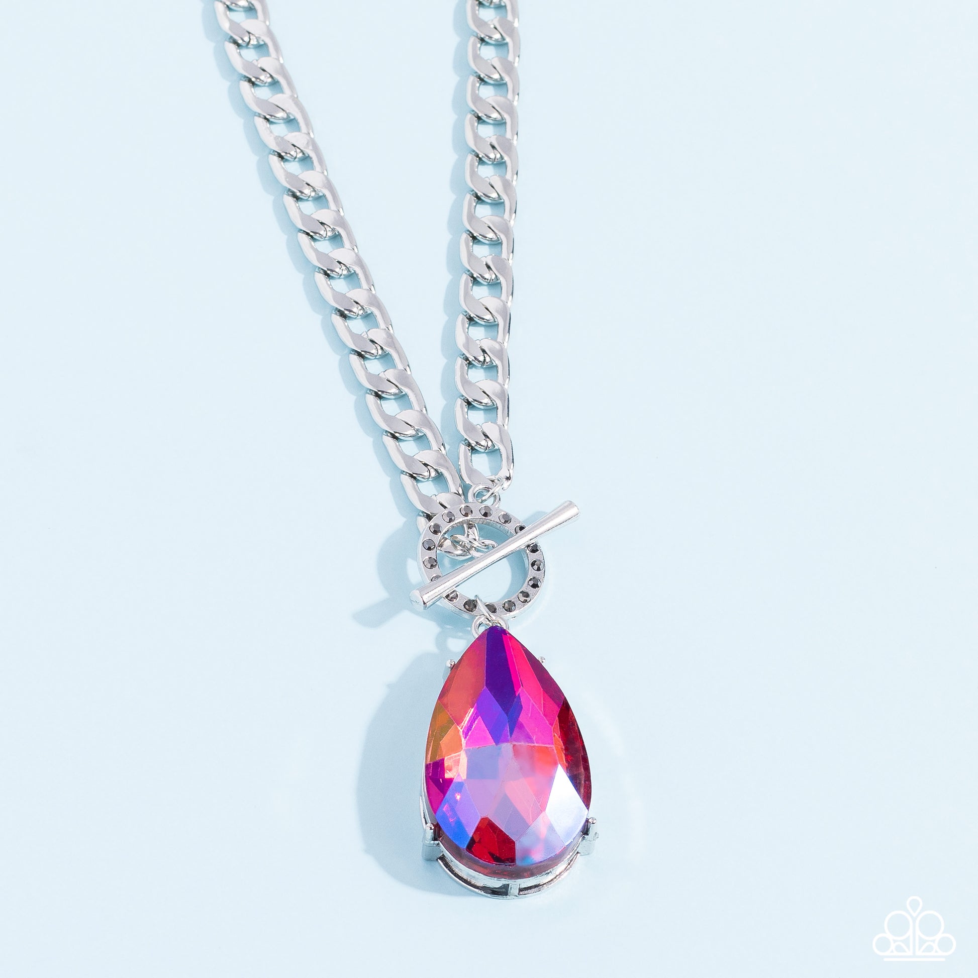 Paparazzi Accessories Edgy Exaggeration - Pink Featuring an elegant lariat closure, an oversized, faceted, stellar pink UV shimmery teardrop gem, encased in an elevated pronged silver frame cascades from the bottom of a silver curb chain in a whimsical fa