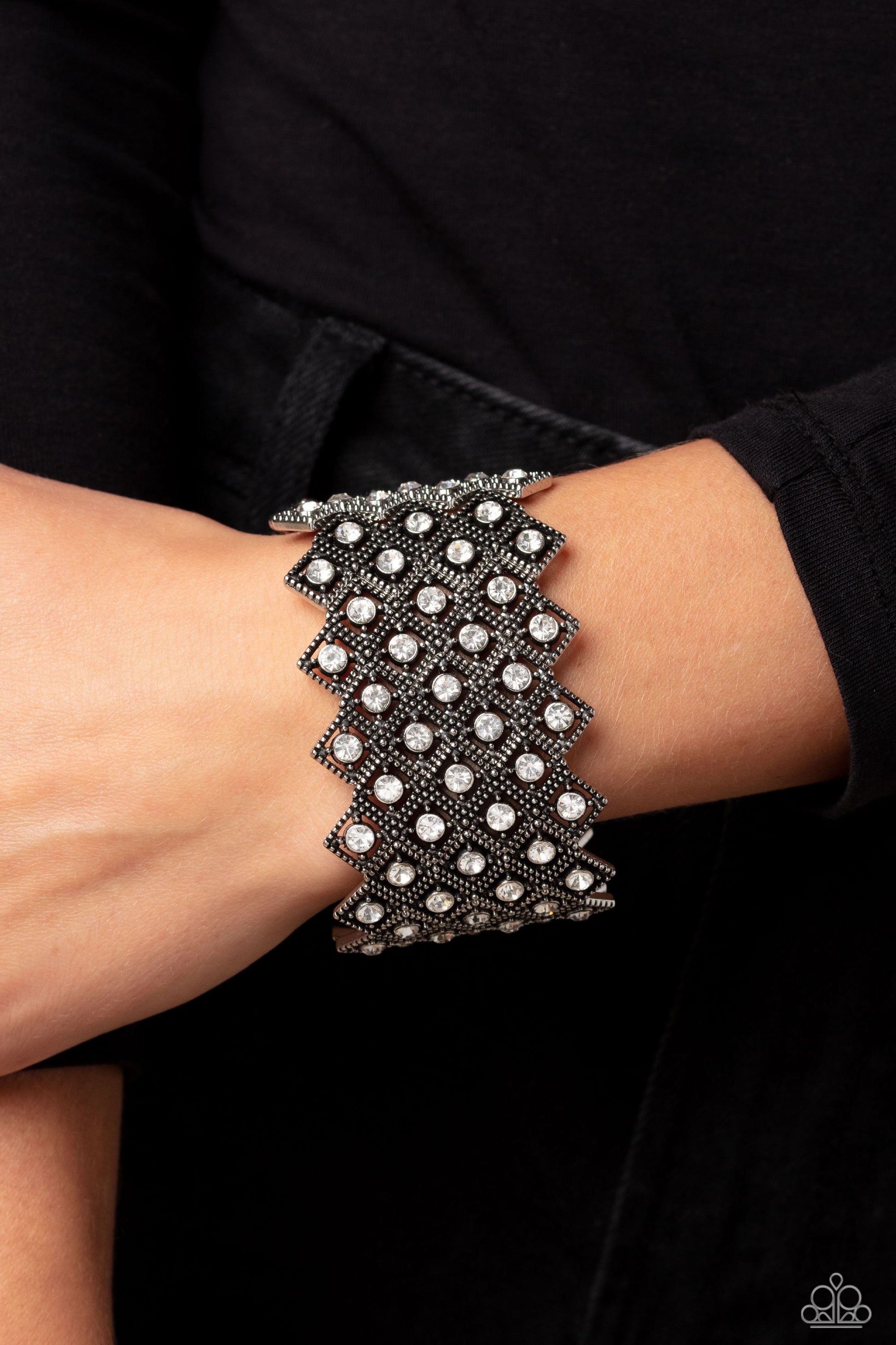 Paparazzi Accessories DECO in the Rough - White Glittery silver-studded diamond frames filled with white rhinestones cluster together in a geometric pattern around the wrist on elastic stretchy bands for a glitzy art deco finish. Sold as one individual br