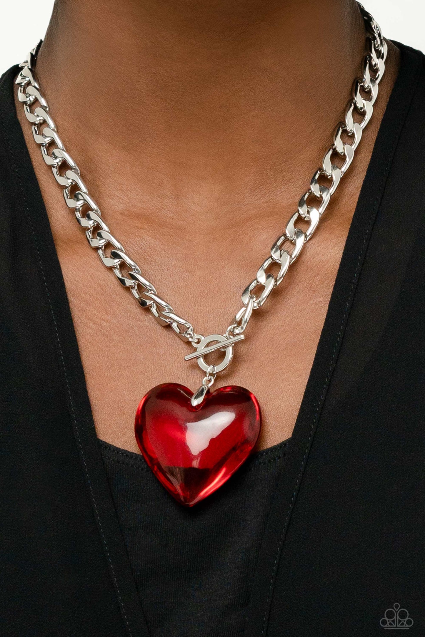 Paparazzi Accessories GLASSY-Hero - Red Featuring a glossy finish, an oversized, rich, red heart gem swings from the bottom of a thick silver curb chain below the collar for a romantic declaration. Features a toggle closure. Sold as one individual necklac
