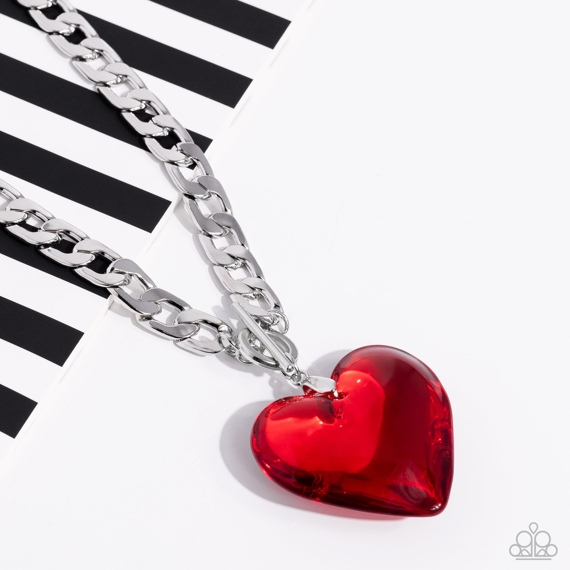 Paparazzi Accessories GLASSY-Hero - Red Featuring a glossy finish, an oversized, rich, red heart gem swings from the bottom of a thick silver curb chain below the collar for a romantic declaration. Features a toggle closure. Sold as one individual necklac