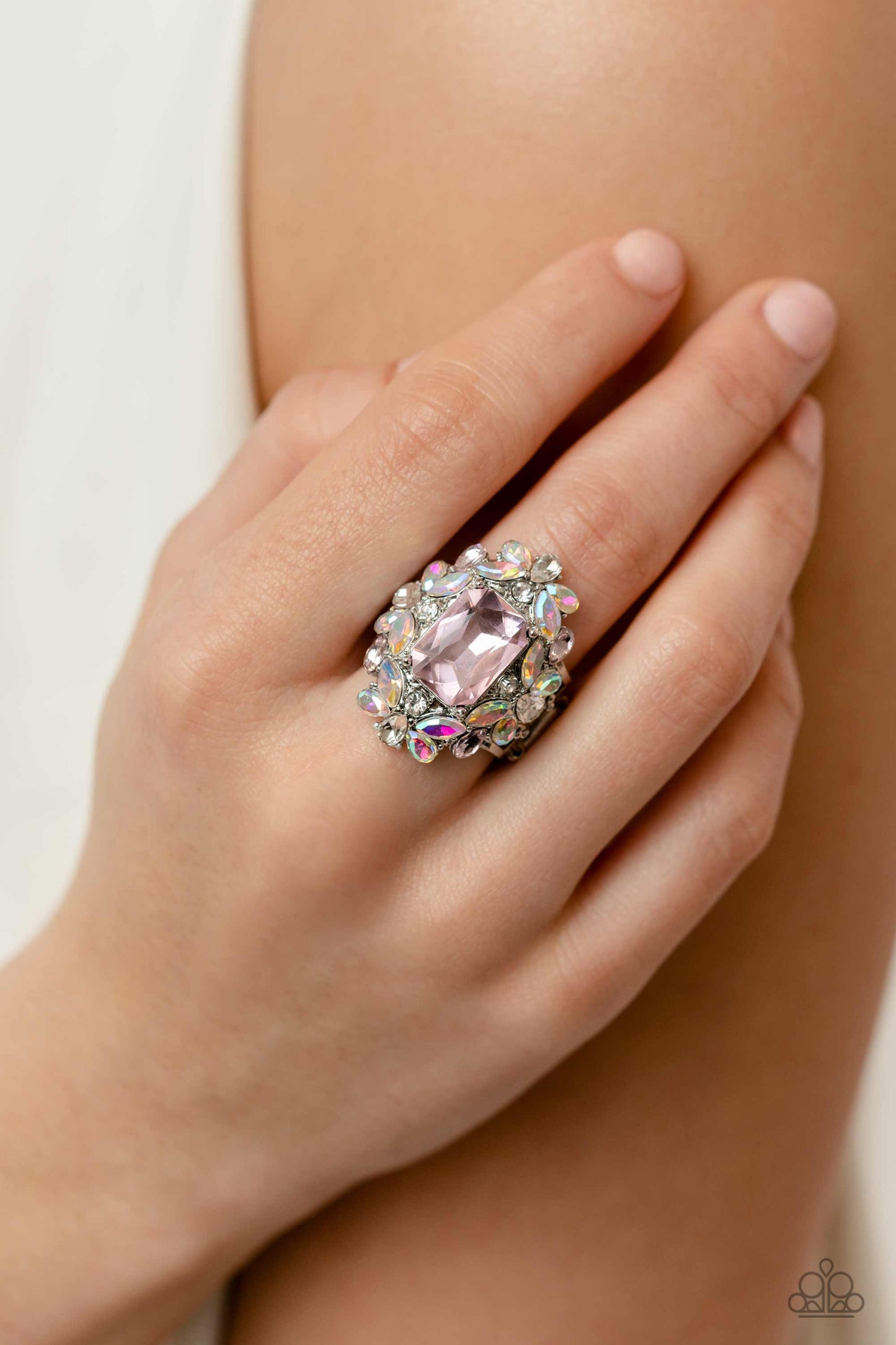 Paparazzi Accessories Dynamic Diadem - Pink A faceted radiant-cut pink gem is pressed into an elaborate frame filled with blinding round, teardrop and marquise-cut gems in shades of white, pink, and iridescent for a blingy statement atop the finger. Featu