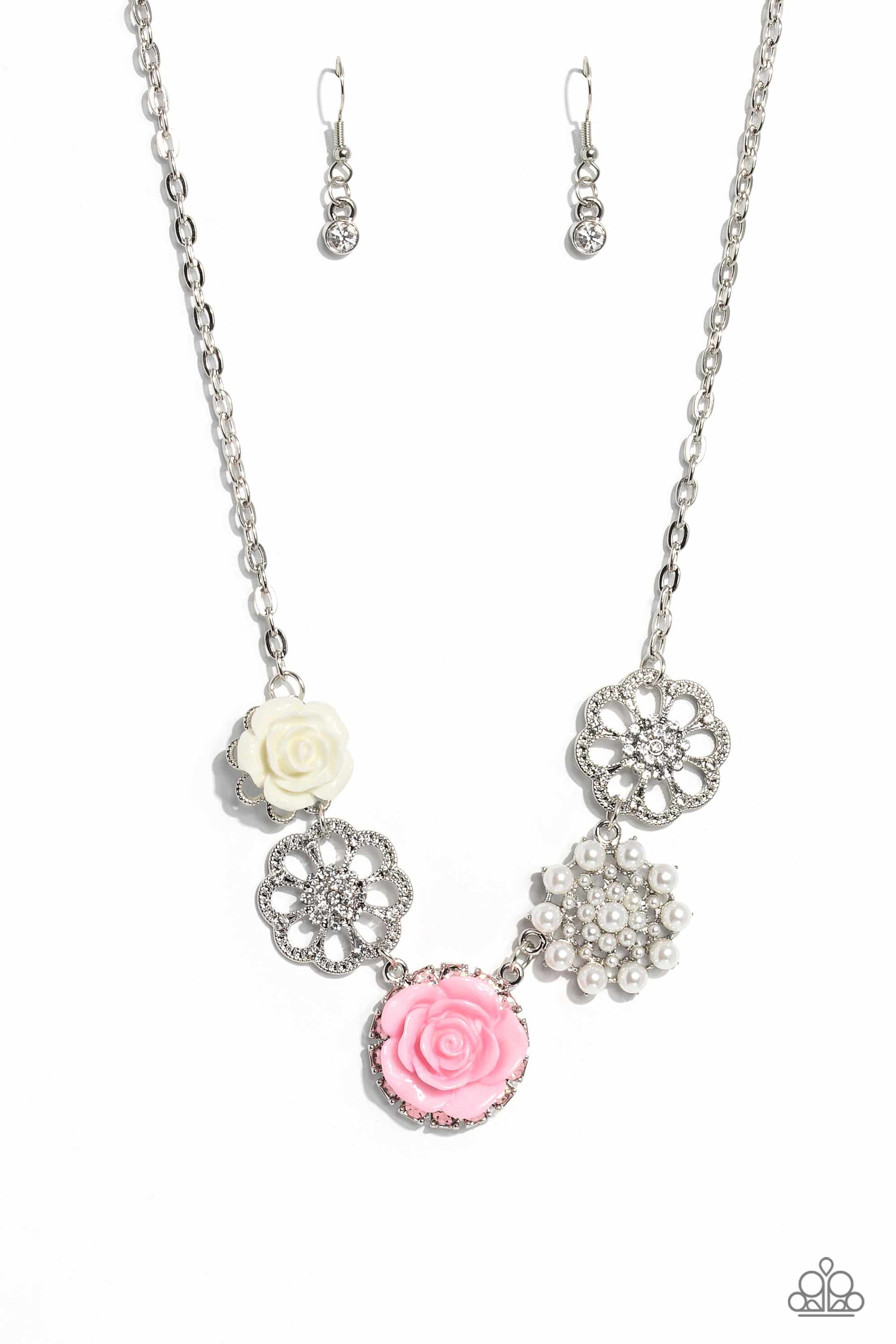 Paparazzi Accessories Tea Party Favors - Pink A collection of whimsical, refined flowers gathers along a flat, sleek silver link chain. The featured charms include an ivory resin rose blooming atop a glittery silver floral silhouette, two silver flowers d