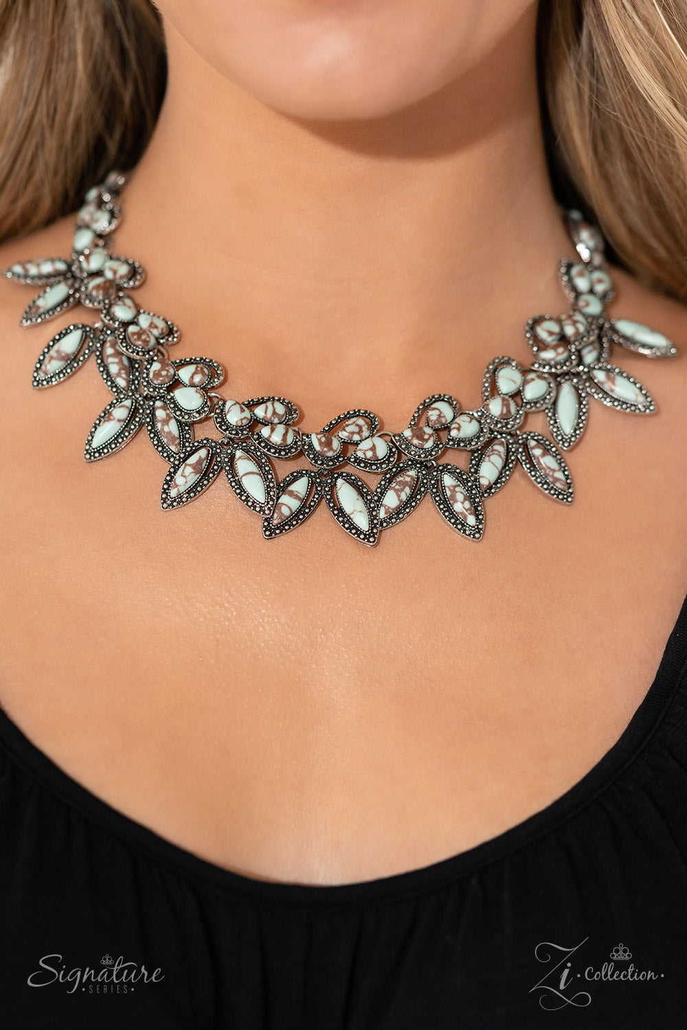 Paparazzi Accessories The April Light blue stones, marbled with rich brown swirls, are polished to perfection and chiseled into teardrops and marquise cuts. The smooth stones are grouped along a thick silver curb chain, creating a leafy display that falls