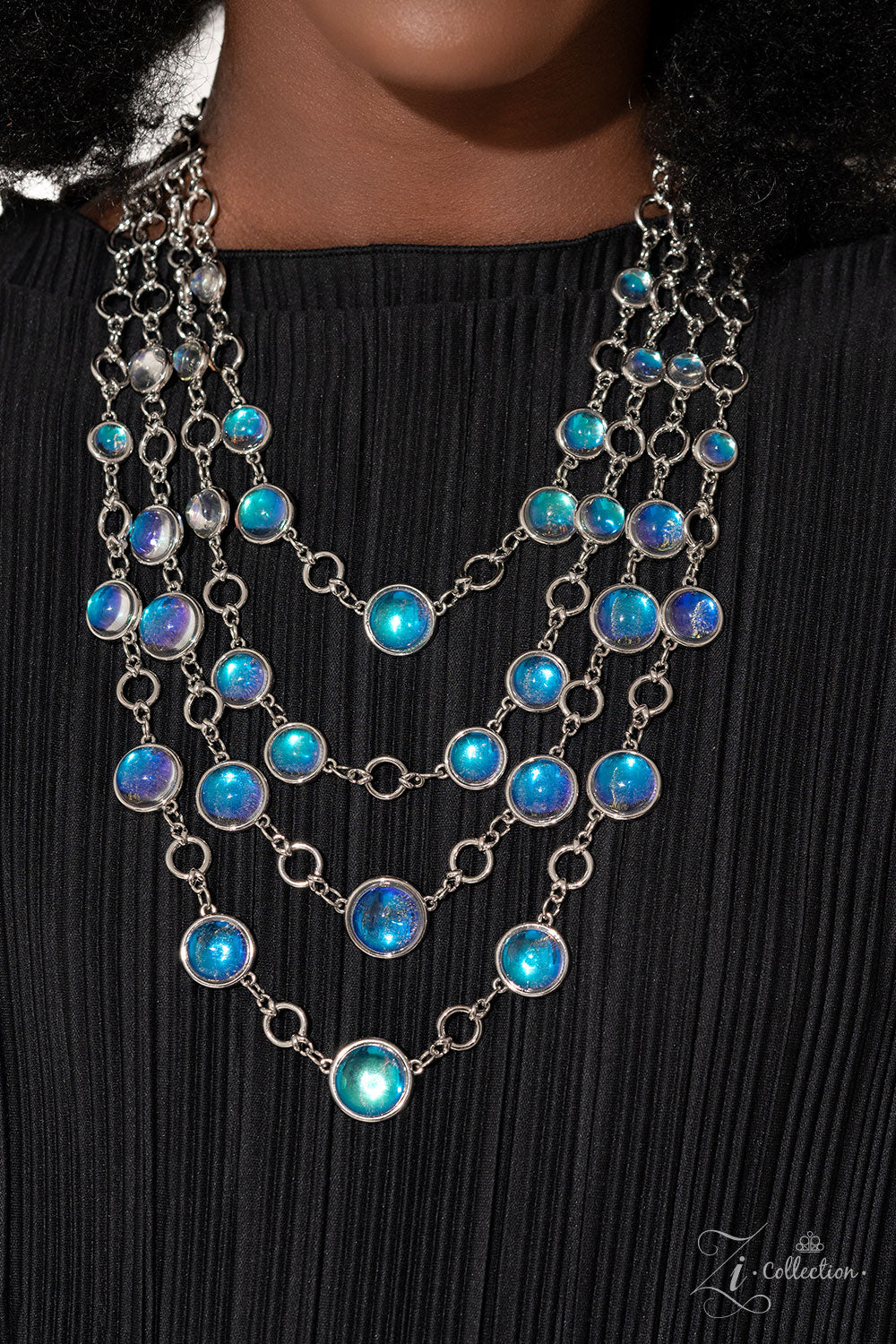 Paparazzi Accessories Hypnotic - Multi A dizzying display of silver hoops drapes across the chest in effervescent layers. Smooth, glassy beads, brushed in swirls of pastel iridescence, bubble up from some of the open, circular frames, further exaggerating