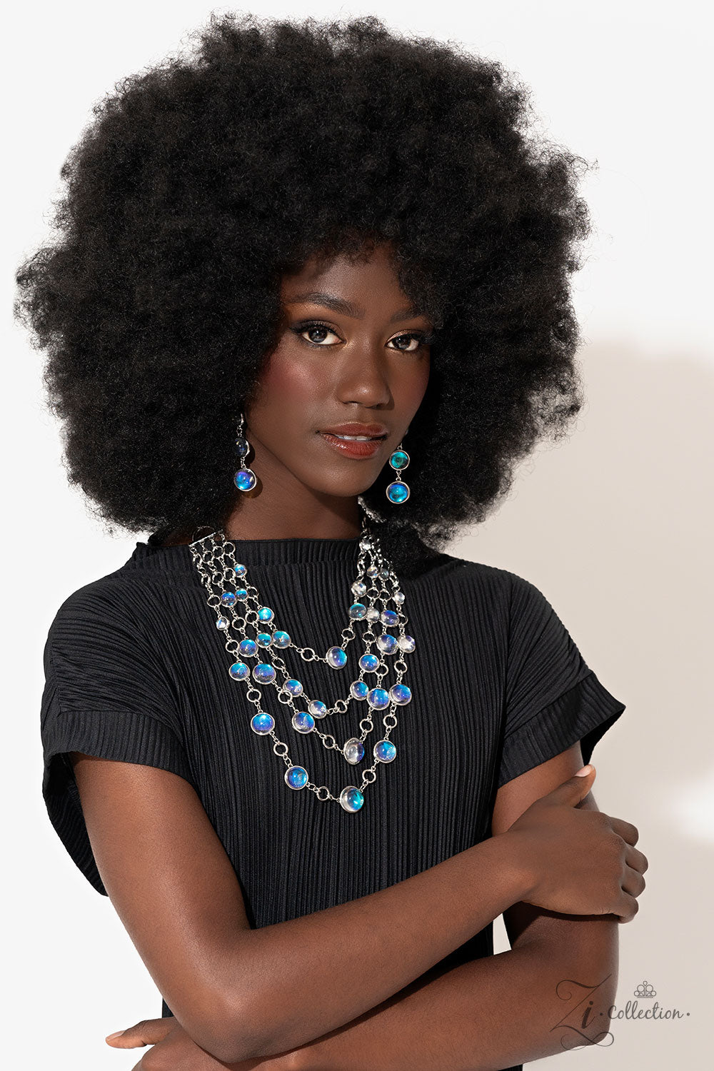 Paparazzi Accessories Hypnotic - Multi A dizzying display of silver hoops drapes across the chest in effervescent layers. Smooth, glassy beads, brushed in swirls of pastel iridescence, bubble up from some of the open, circular frames, further exaggerating