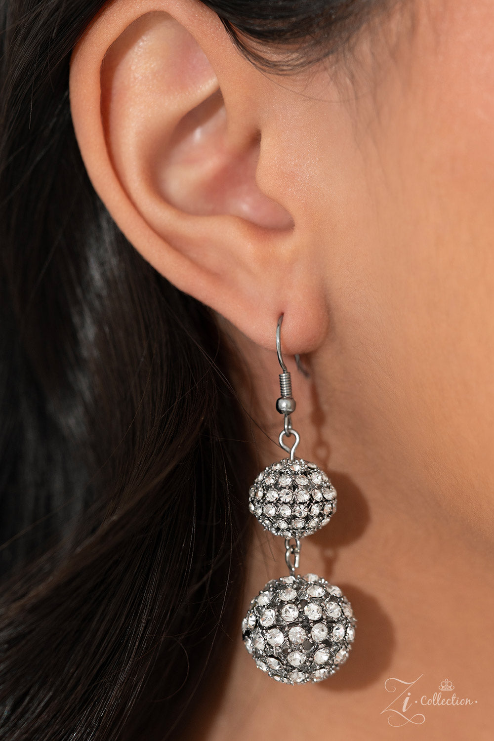 Paparazzi Accessories Undaunted - White Glittery, white rhinestones cluster together, creating dramatically oversized, airy, spheres that sparkle vivaciously. Smaller rhinestone-encrusted spheres dance between the exaggerated accents, resulting in a dynam