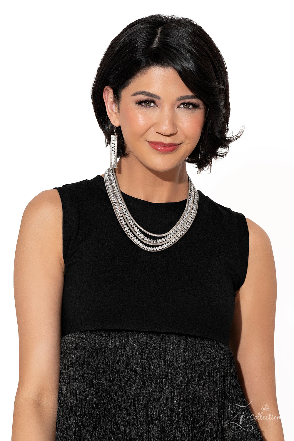 Paparazzi Accessories Tenacious - White Flat, silver snake chains alternate with rows of explosive sparkle, layering into a dynamic lineup of grit and glitz. The meticulous placement and uniform sizing of the glittery, white rhinestones are contrasted by