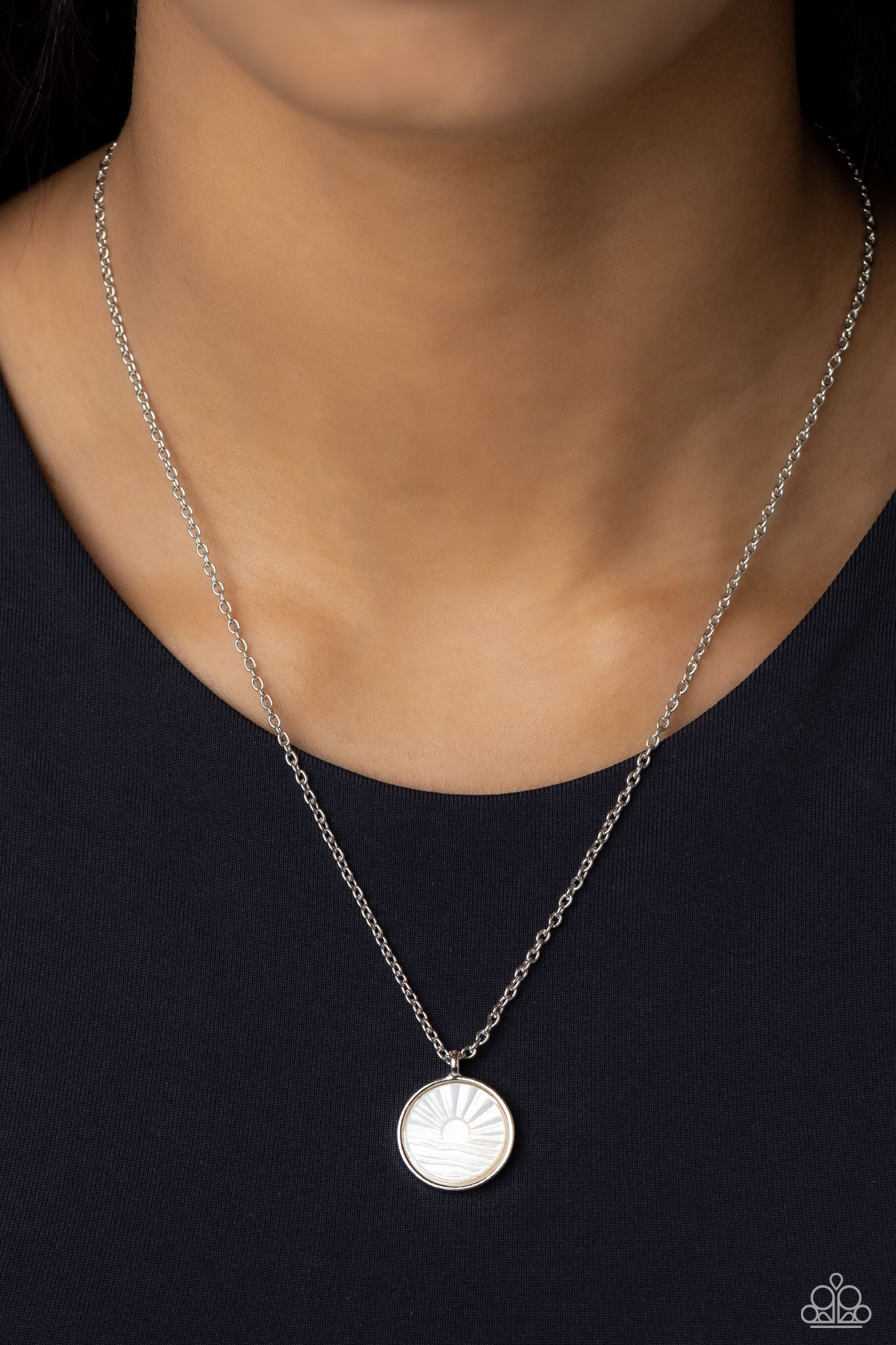 Paparazzi Accessories Seize the Sunset - White Encased in a sleek silver frame, a white, shell-like disc swings from the bottom of a dainty silver chain below the collar. Embossed onto the iridescent shell, a sun sets over the ocean waves for a beach-insp