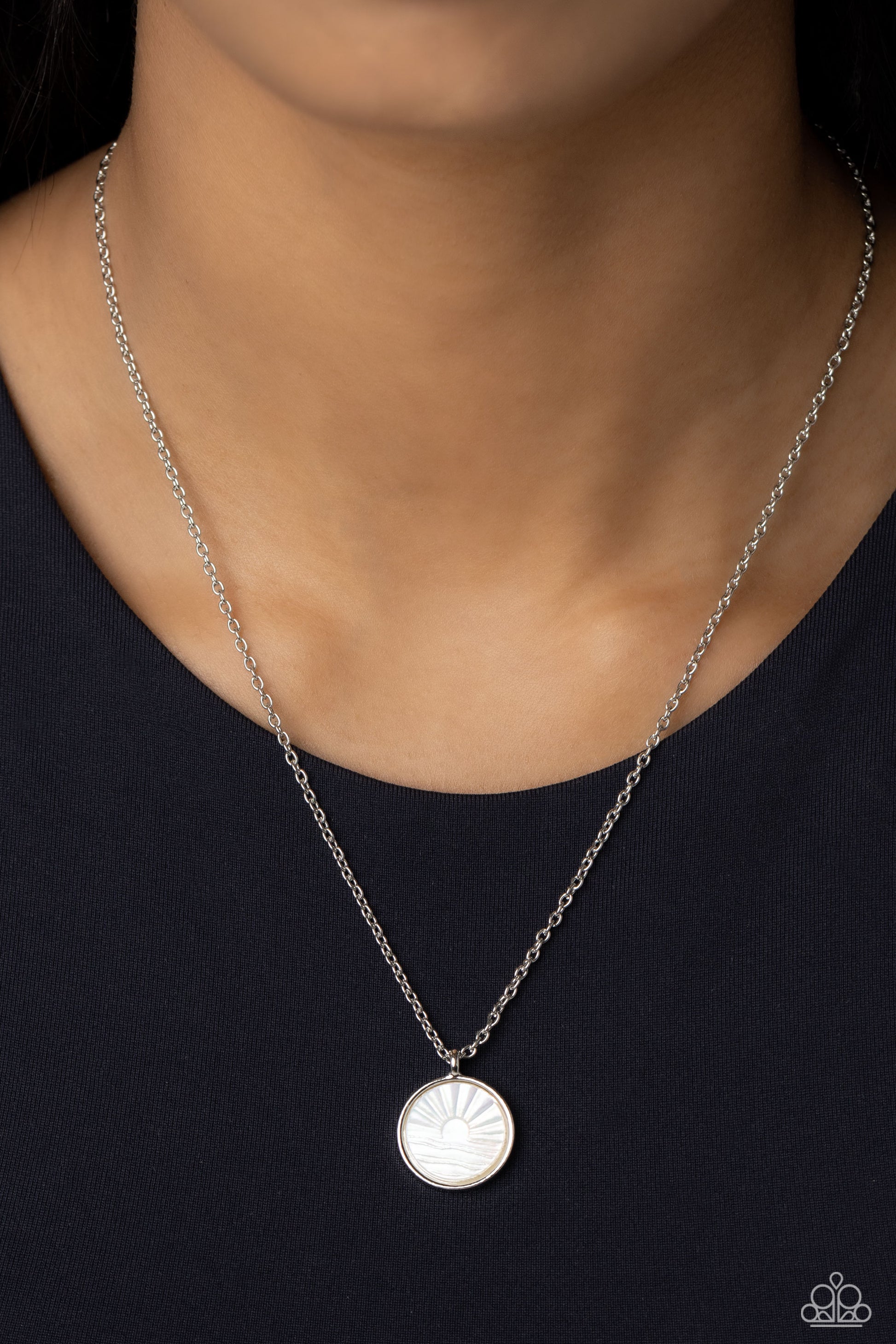 Paparazzi Accessories Seize the Sunset - White Encased in a sleek silver frame, a white, shell-like disc swings from the bottom of a dainty silver chain below the collar. Embossed onto the iridescent shell, a sun sets over the ocean waves for a beach-insp