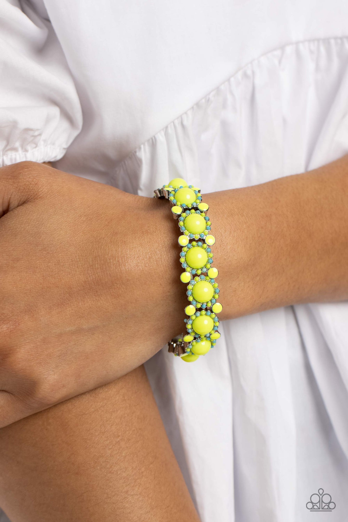 Paparazzi Accessories Pop Art Party - Green Dotted in glossy Love Bird beaded centers, turquoise and Love Bird beaded silver floral frames delicately link around the wrist on stretchy bands for a whimsical arrangement. Separating each floral display, addi