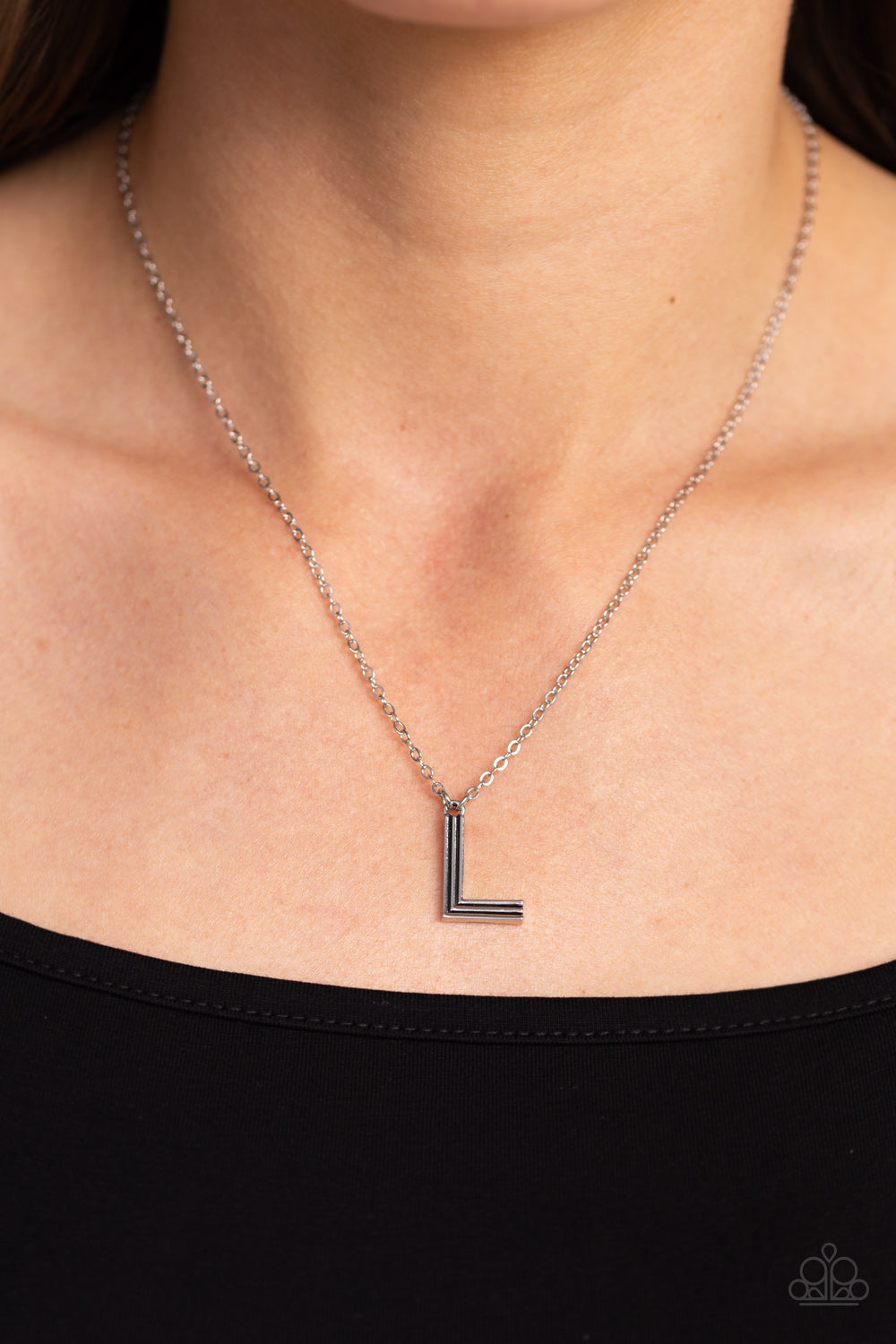 Paparazzi Accessories Leave Your Initials - Silver - L Etched in linear texture, a silver letter "L" glides down the neckline from a dainty silver chain, for a sentimentally simple design. Features an adjustable clasp closure. Sold as one individual neckl