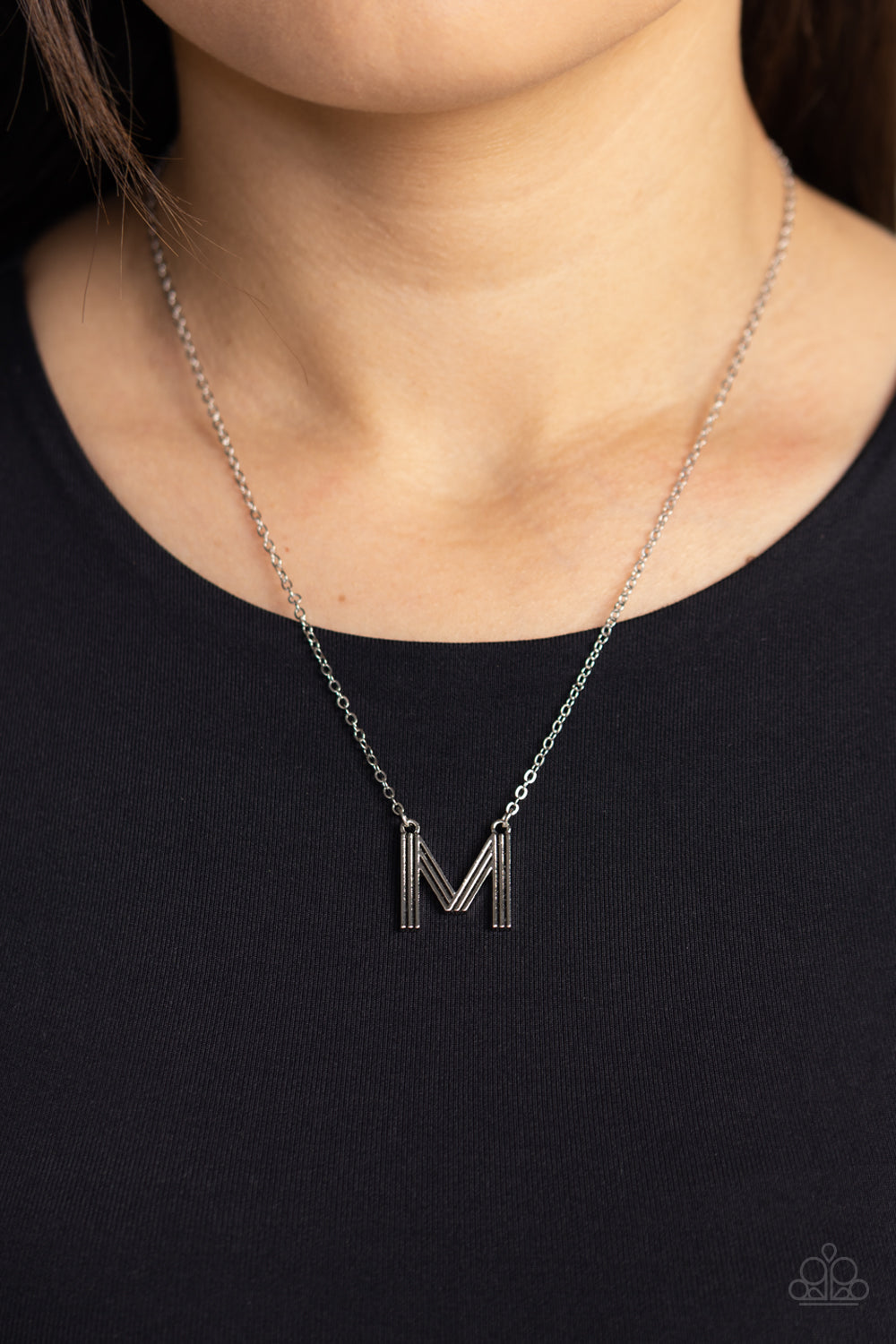 Paparazzi Accessories Leave Your Initials - Silver - M Etched in linear texture, a silver letter "M" hovers below the collar from a dainty silver chain, for a sentimentally simple design. Features an adjustable clasp closure. Sold as one individual neckla